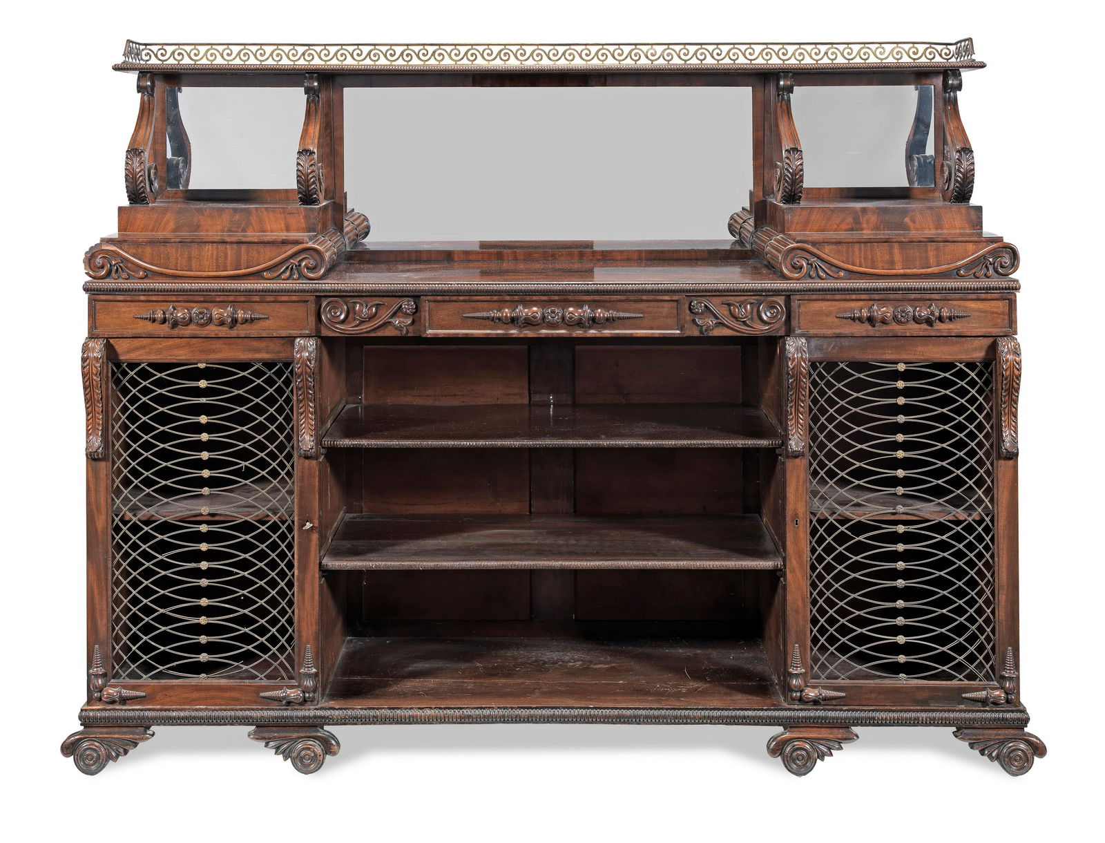 A George IV mahogany low cabinet or low bookcase possibly by John Taylor or after his designs: A George IV mahogany low cabinet or low bookcase possibly by John Taylor or after his designs Circa 1830, with reeded mouldings and lotus-leaf, honeysuckle and rosette carved decoration, the superstru