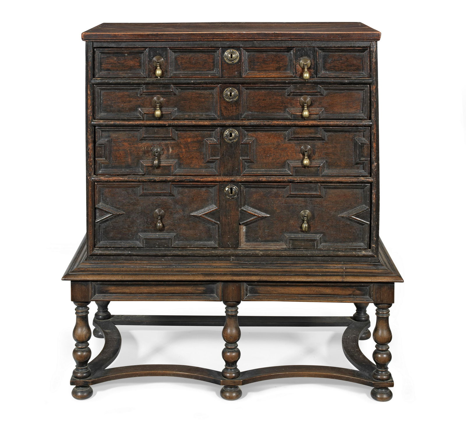 An 18th century oak chest on later stand: An 18th century oak chest on later stand The rectangular top above four long drawers, with geometric moulded panels, set on a later stand with turned legs, united with concave stretchers, on bun feet,