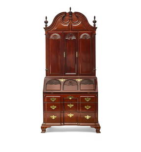 A CHIPPENDALE STYLE CARVED MAHOGANY BLOCK AND SHELL SECRETARY BOOKCASEAfter a model from the Tow...: A CHIPPENDALE STYLE CARVED MAHOGANY BLOCK AND SHELL SECRETARY BOOKCASE After a model from the Townsend and Goddard workshop, Newport, Rhode Island, 20th century, Kindel Furniture Company, Grand Rapids