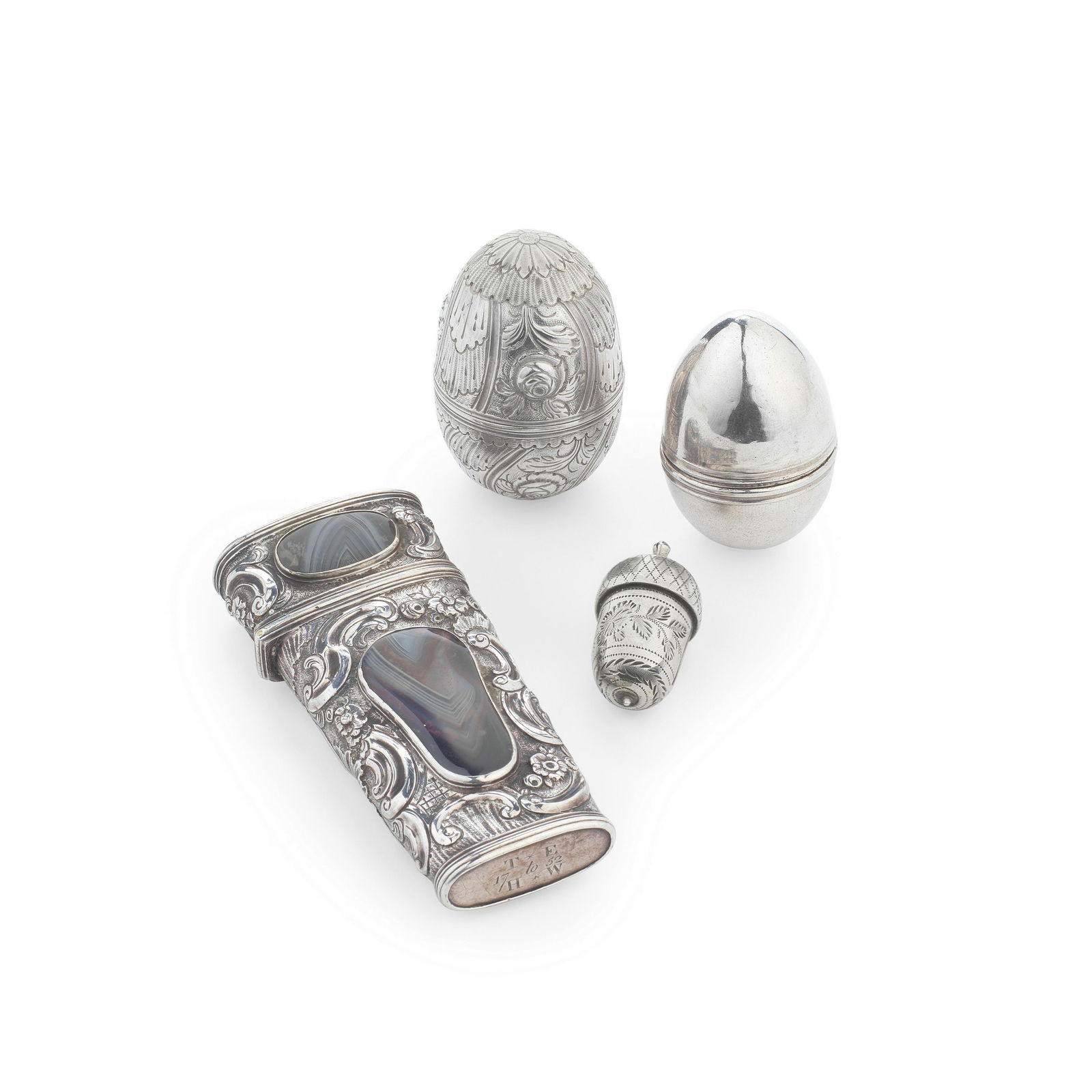 Two 18th century silver nutmeg graters by Samuel Meriton and ten further items (12): Two 18th century silver nutmeg graters Samuel Meriton Both egg form, one plain, the other with floral and scroll decoration, lengths 4.2cm and 5cm, together with a jockey's cap tea caddy spoon, by Jos
