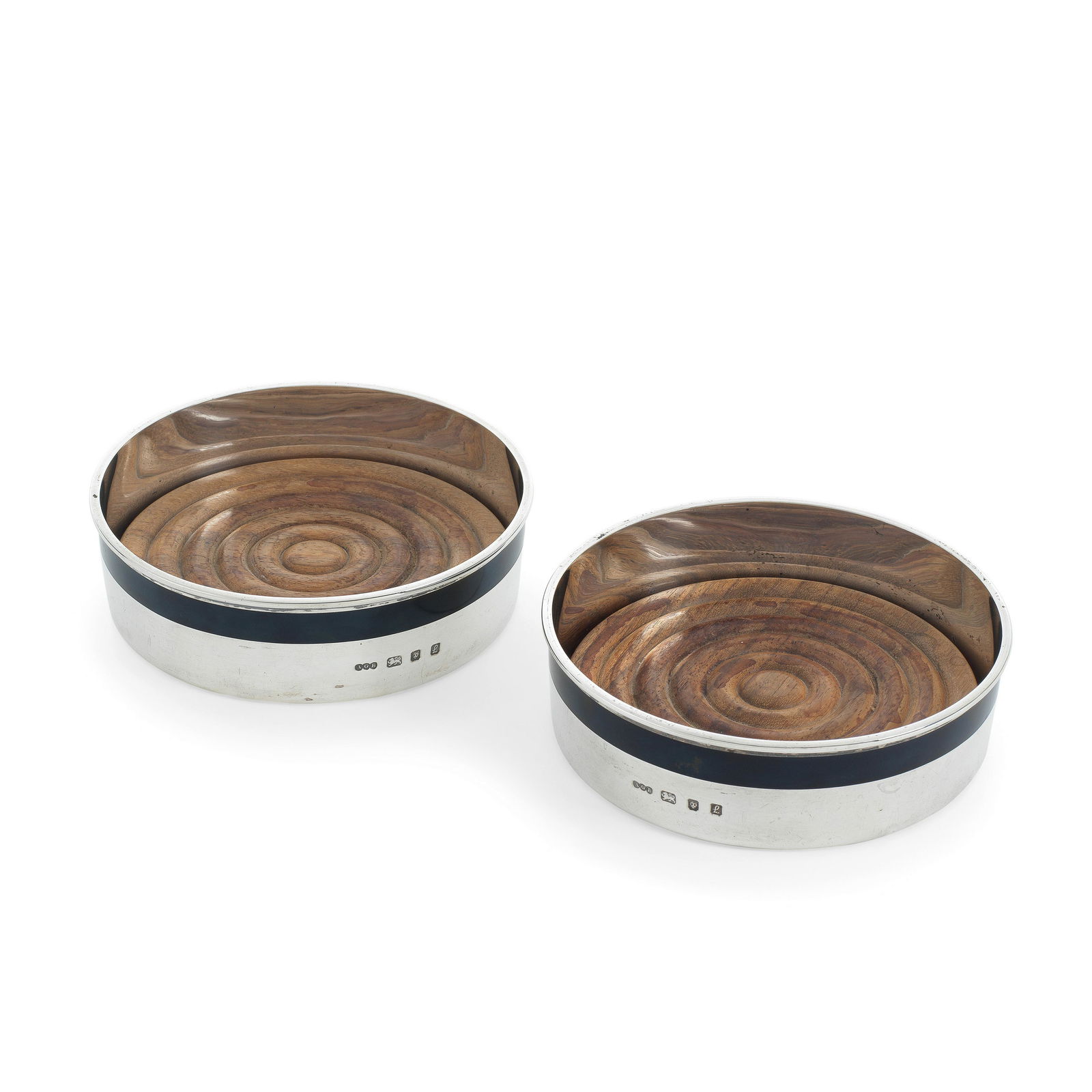 GERALD BENNEY: a pair of silver and enamel wine coasters London 1985 (2): GERALD BENNEY: a pair of silver and enamel wine coasters London 1985 Circular form, the upper border decorated with a black enamel band against a plain polished body, with a removable turned wooden b