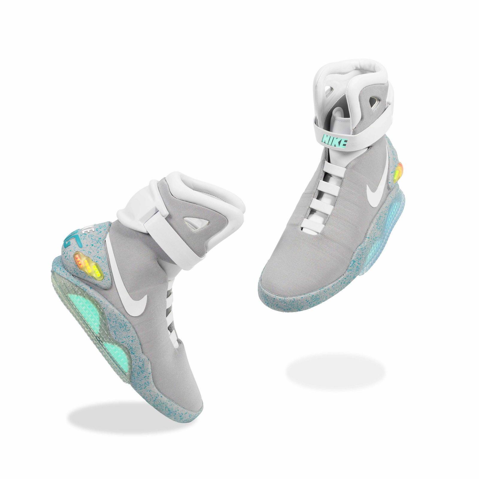 Nike MAG A Pair of 'Back To The Future' Sneakers, 2011: Nike MAG A Pair of 'Back To The Future' Sneakers, 2011 grey leather, rubber, cotton, mesh, and plastic with electric components, includes original packaging, enamel pin badge, paddle from online aucti