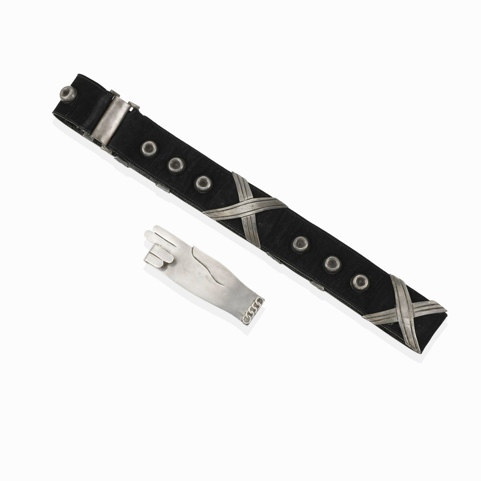 A SILVER AND SUEDE BELT WITH SILVER BUCKLE, MEXICO: A SILVER AND SUEDE BELT WITH SILVER BUCKLE, MEXICO A suede belt accented by silver circles and 'X' motifs together with a belt buckle of a hand design, belt Hector Aguilar, buckle Hubert Harmon, belt