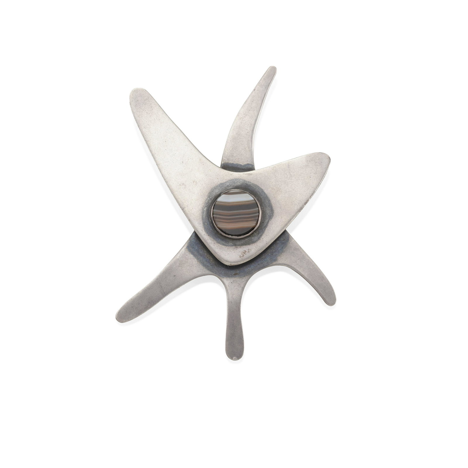 ED WIENER: A SILVER AND BANDED AGATE BROOCH: ED WIENER: A SILVER AND BANDED AGATE BROOCH Featuring a round banded agate tablet set in a layered abstract design, signed Ed Wiener, measures 3 3/8 x 2 1/2 in. Footnotes: Literature: Illustrated in: