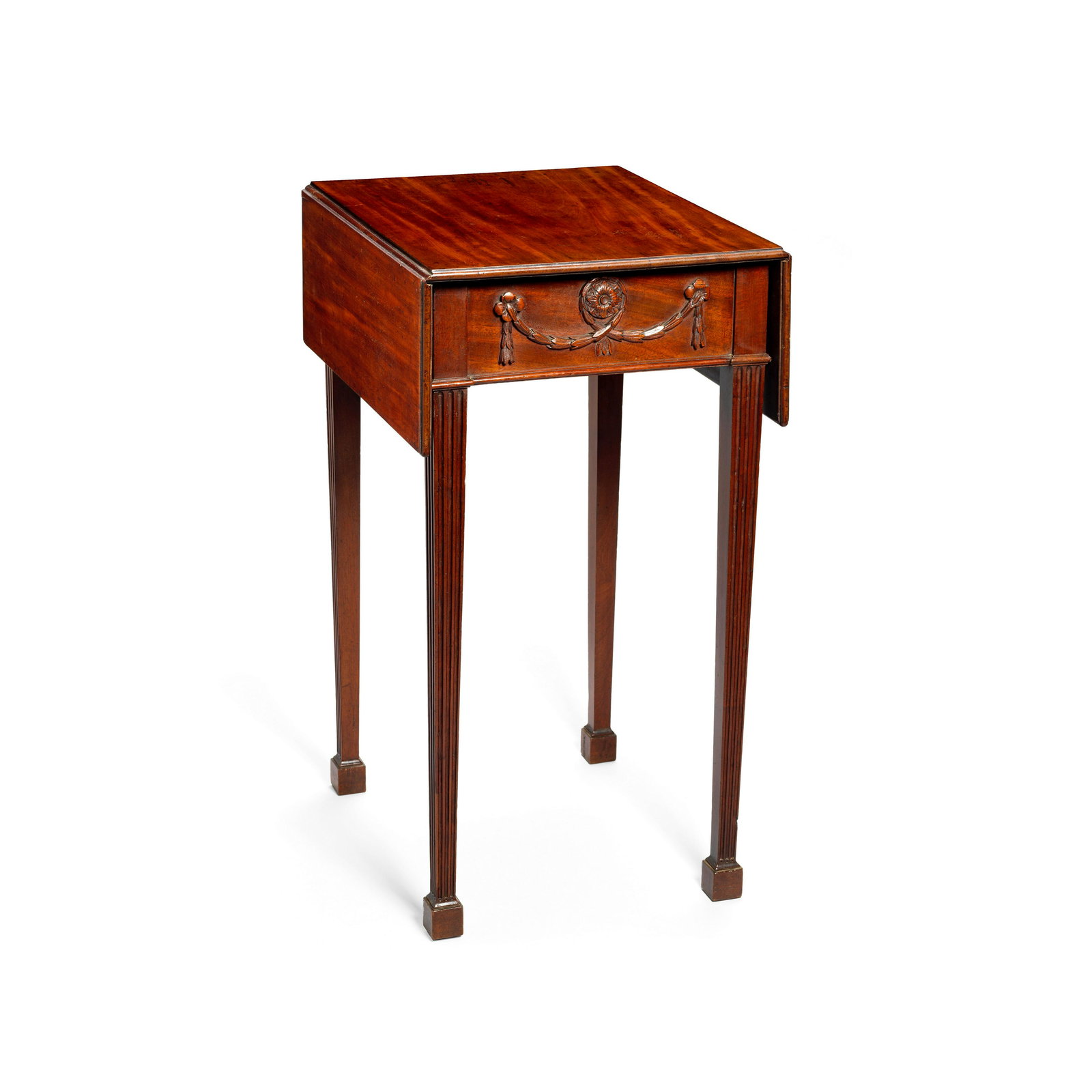 A George III mahogany Pembroke table Circa 1775: A George III mahogany Pembroke table Circa 1775 The rectangular top with an ovolo moulded edge above an opposing frieze carved to each end with rosette-hung husk festoons centred by a flowerhead, on s