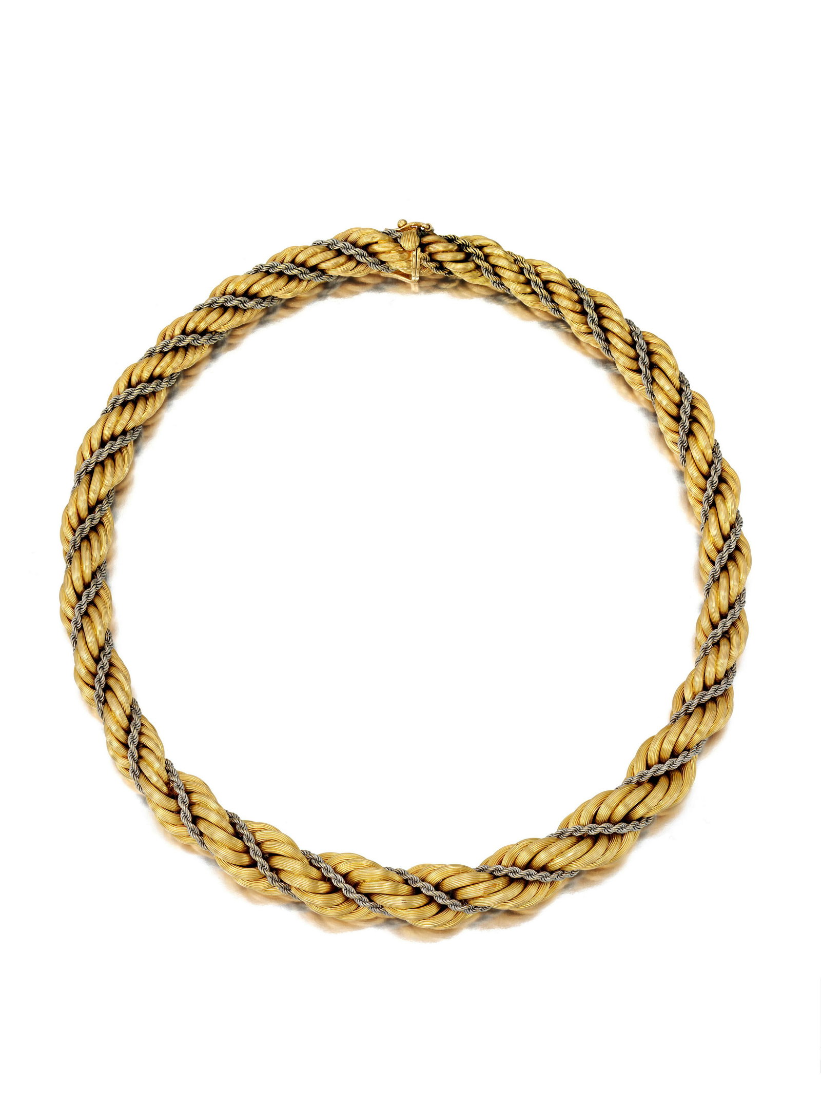 AN 18K BICOLORED GOLD NECKLACE: AN 18K BICOLORED GOLD NECKLACE Designed as intertwined graduated yellow and white gold rope chains; with maker's mark; gross approximate weight 78.8 g; length 16 in. Footnotes: Throughout the twentiet