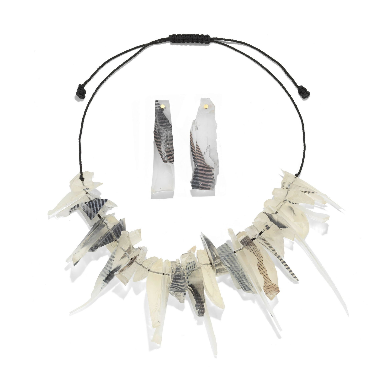 RON ARAD: 'ROCKS N.VIII' NECKLACE, 'ROCKS E.III' EARRINGS. (2): RON ARAD: 'ROCKS N.VIII' NECKLACE, 'ROCKS E.III' EARRINGS. The fringe necklace formed with shards of silicon and silk designed to look like rocks, on a cord necklace, the drop earrings of similar desi
