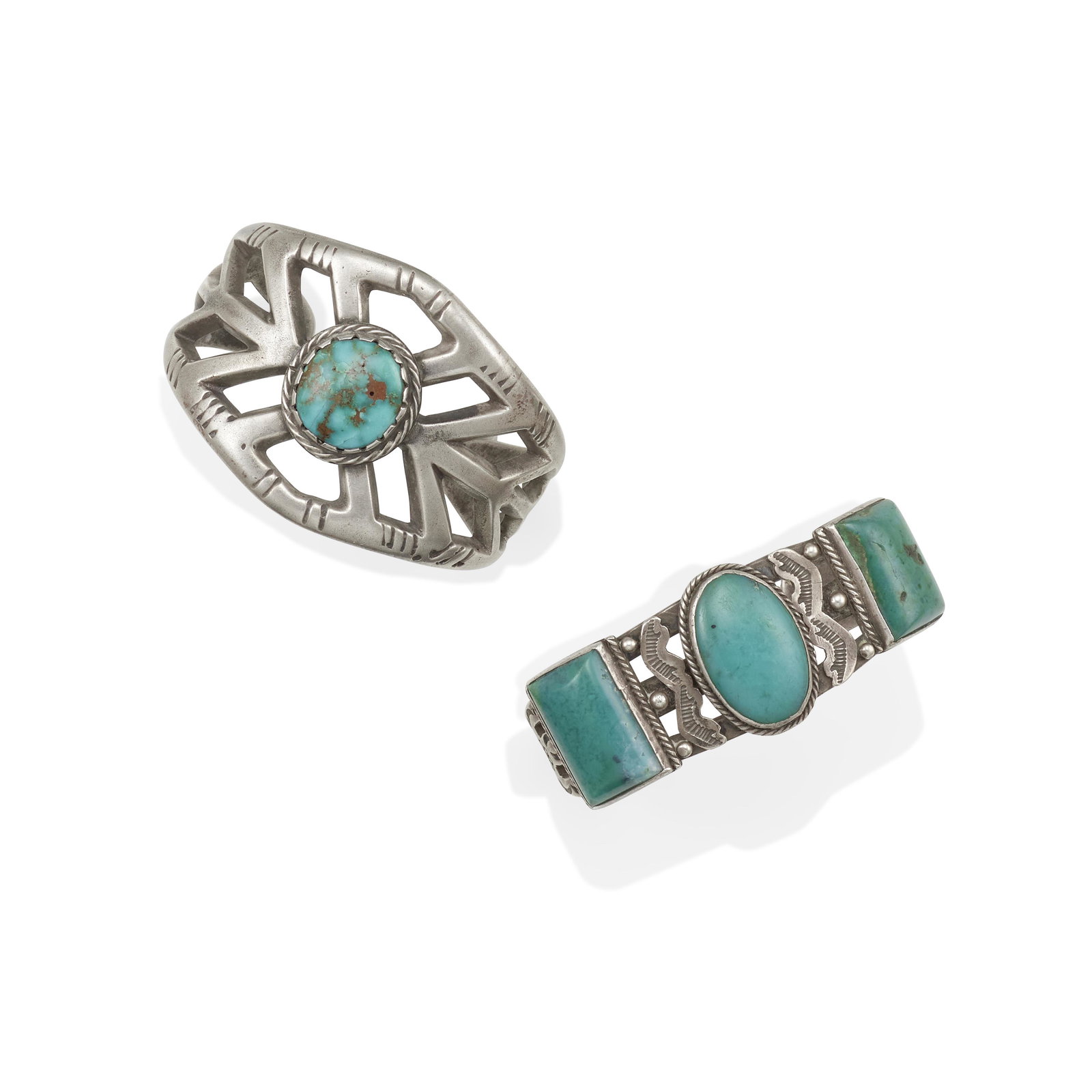 Two silver & turquoise cuff bracelets: Two silver & turquoise cuff bracelets Comprising a sand-cast cuff centering a circular turquoise and a stamped pierced cuff supporting two rectangular and one oblong turquoise. each inner circumferenc