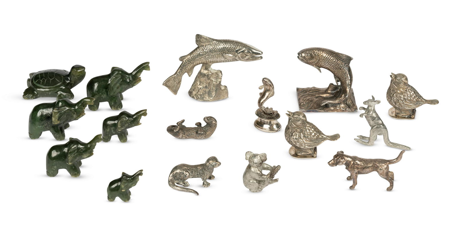 A collection of silver, white metal and nephrite animals Various makers and dates (16): A collection of silver, white metal and nephrite animals Various makers and dates Comprising five silver animals; a salmon (Asprey, London, 1986); two otters (Sarah Jones, London, possibly 1990); a d