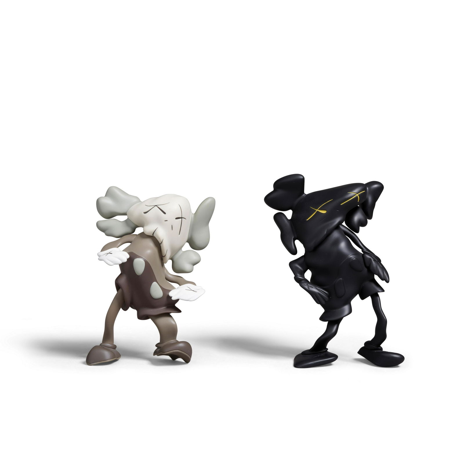 KAWS (born 1974); X Robert Lazzarini Two Companions (LAZZARINI version) (Brown; Black); (2): KAWS (born 1974), X Robert Lazzarini Two Companions (LAZZARINI version) (Brown; Black), 2011 Painted cast vinyl multiples, each stamped with the artist's name, collaborator, date and fabricator 'MEDIC