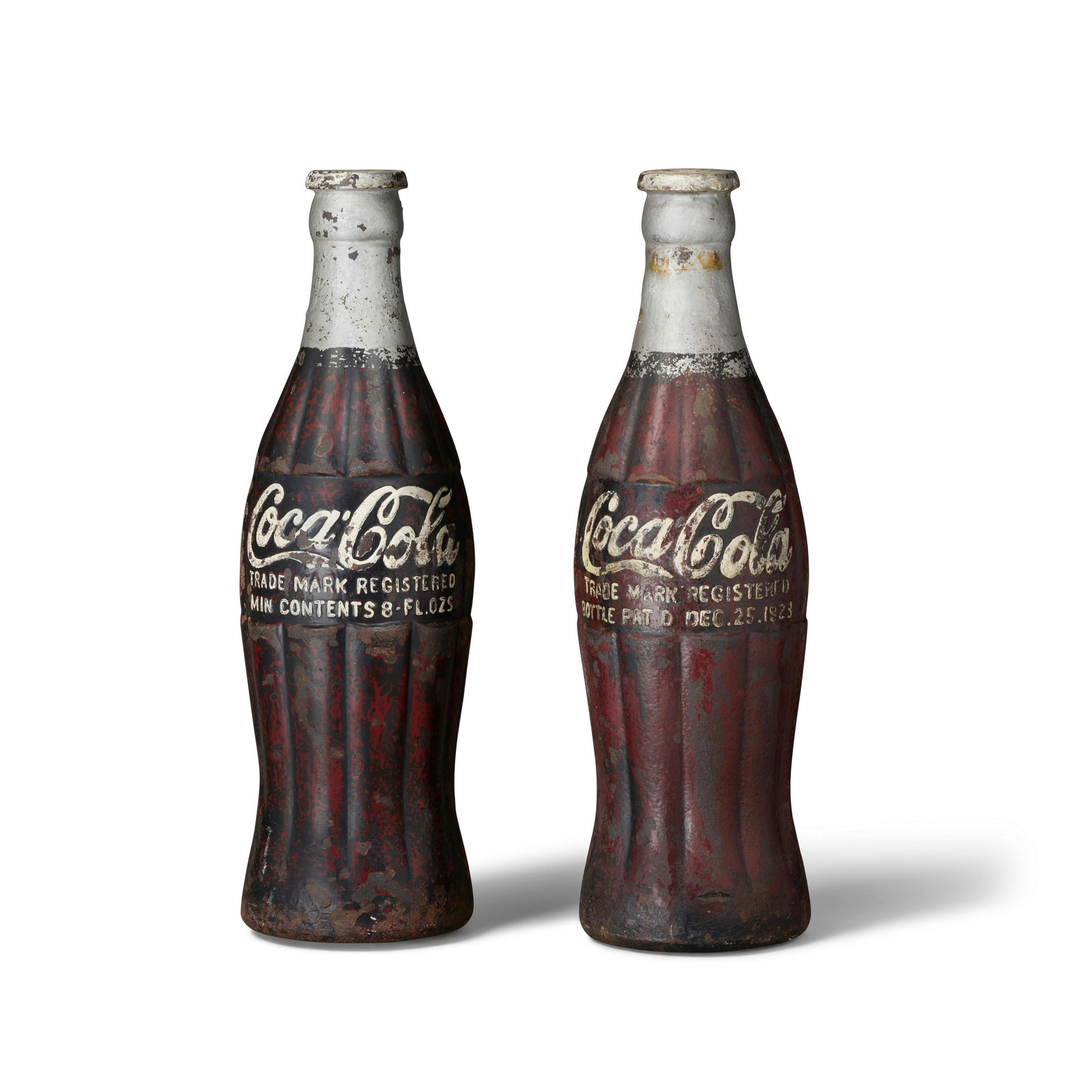 A RARE COMPANION PAIR OF PAINTED CAST IRON COCA-COLA BOTTLE SCULPTURES circa 1923height 20in (51cm) (1 of 1)