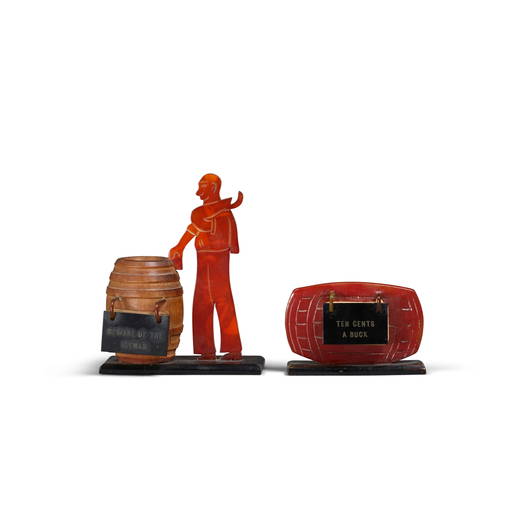 TWO BAKELITE FIGURAL RECIPE STANDS with a red barrel stand and a bound