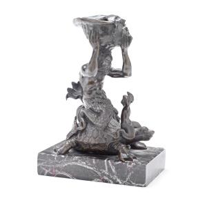 A late 19th century patinated bronze figural group of a triton and infant riding on a tortoise i...: A late 19th century patinated bronze figural group of a triton and infant riding on a tortoise in the Renaissance style the semi-nude male raising a large conch shell above his head, the whole raised 