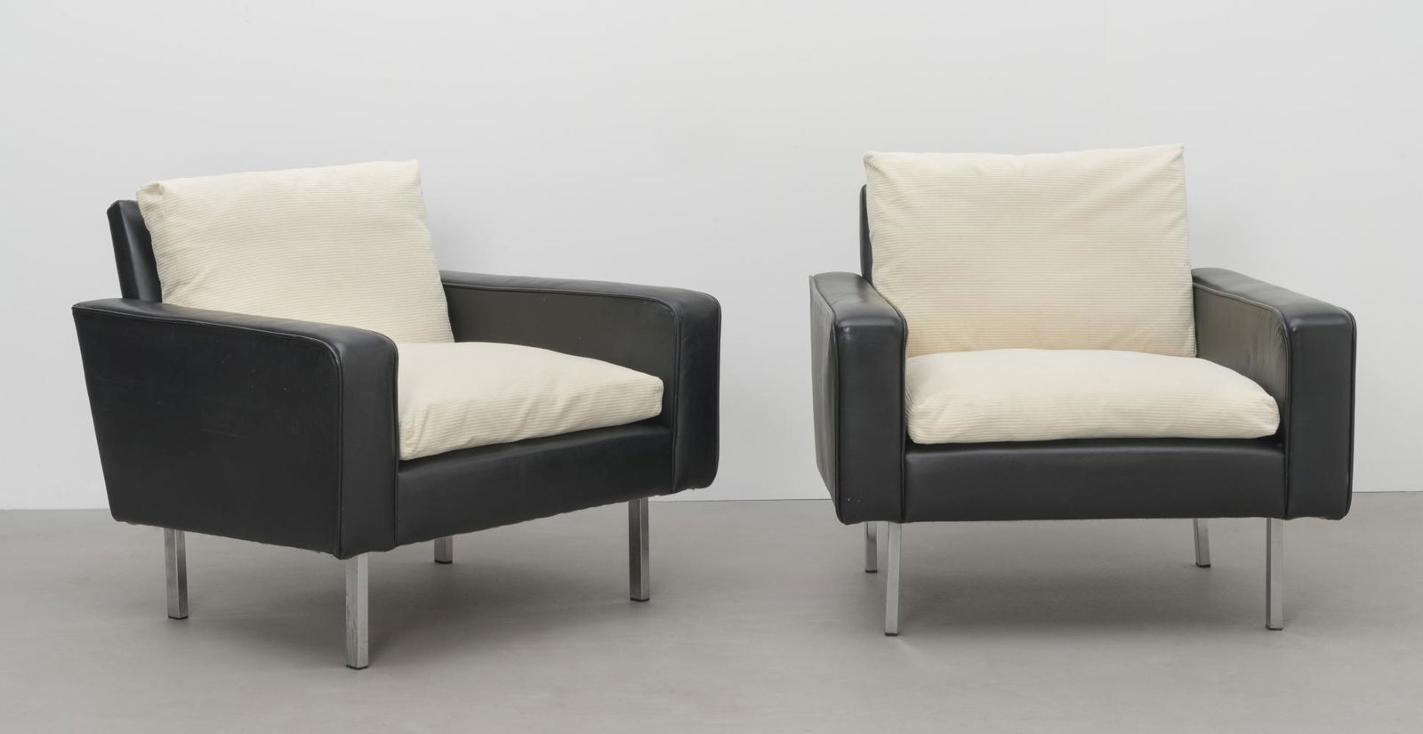 In the style of Robin Day Pair of armchairs, 20th century: In the style of Robin Day Pair of armchairs, 20th century Leather and fabric upholstery, chromium-plated steel. Each: 68.5 cm high, 82.5 cm wide, 75 cm deep This lot is subject to the following lot sy