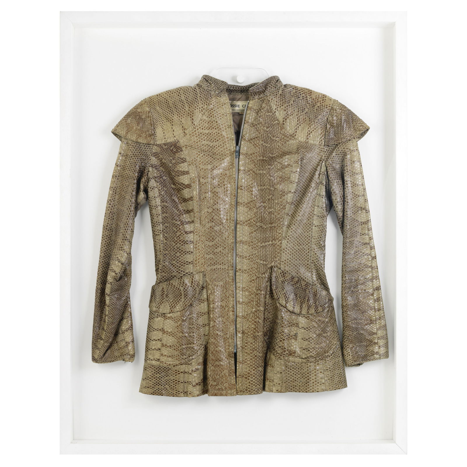 Ossie Clark (British, 1942-1996) Framed Python Skin Jacket, circa 1966: Ossie Clark (British, 1942-1996) Framed Python Skin Jacket, circa 1966 natural brown python skin with slanted round patch pockets and zip down front, displayed in a large white frame with Perspex fron