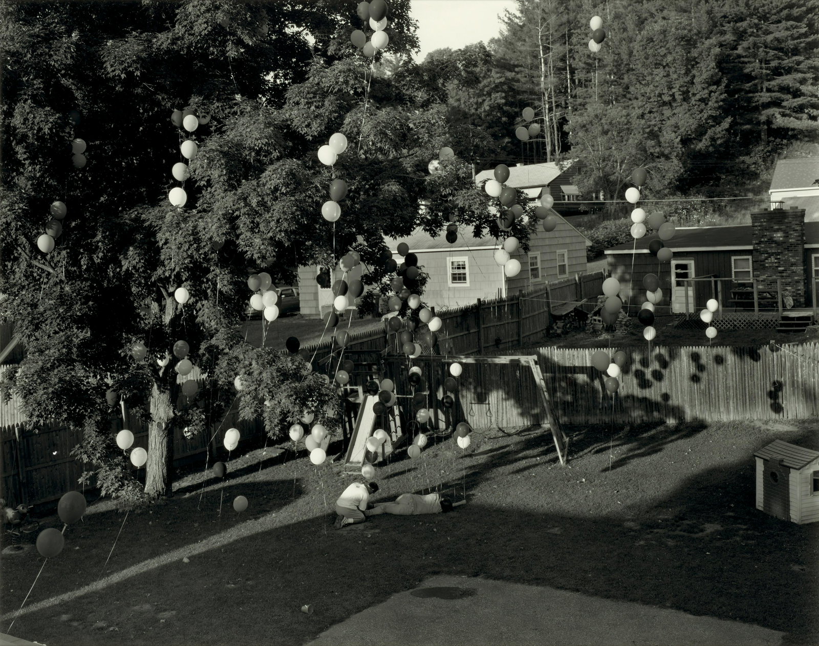 Gregory Crewdson (born 1962); Untitled (balloons in backyard) (from the series 'Hover');: Gregory Crewdson (born 1962) Untitled (balloons in backyard) (from the series 'Hover'), 1996 Gelatin silver print; signed and editioned '5/6' in pencil in the margin, signed in ink on a Luhring August