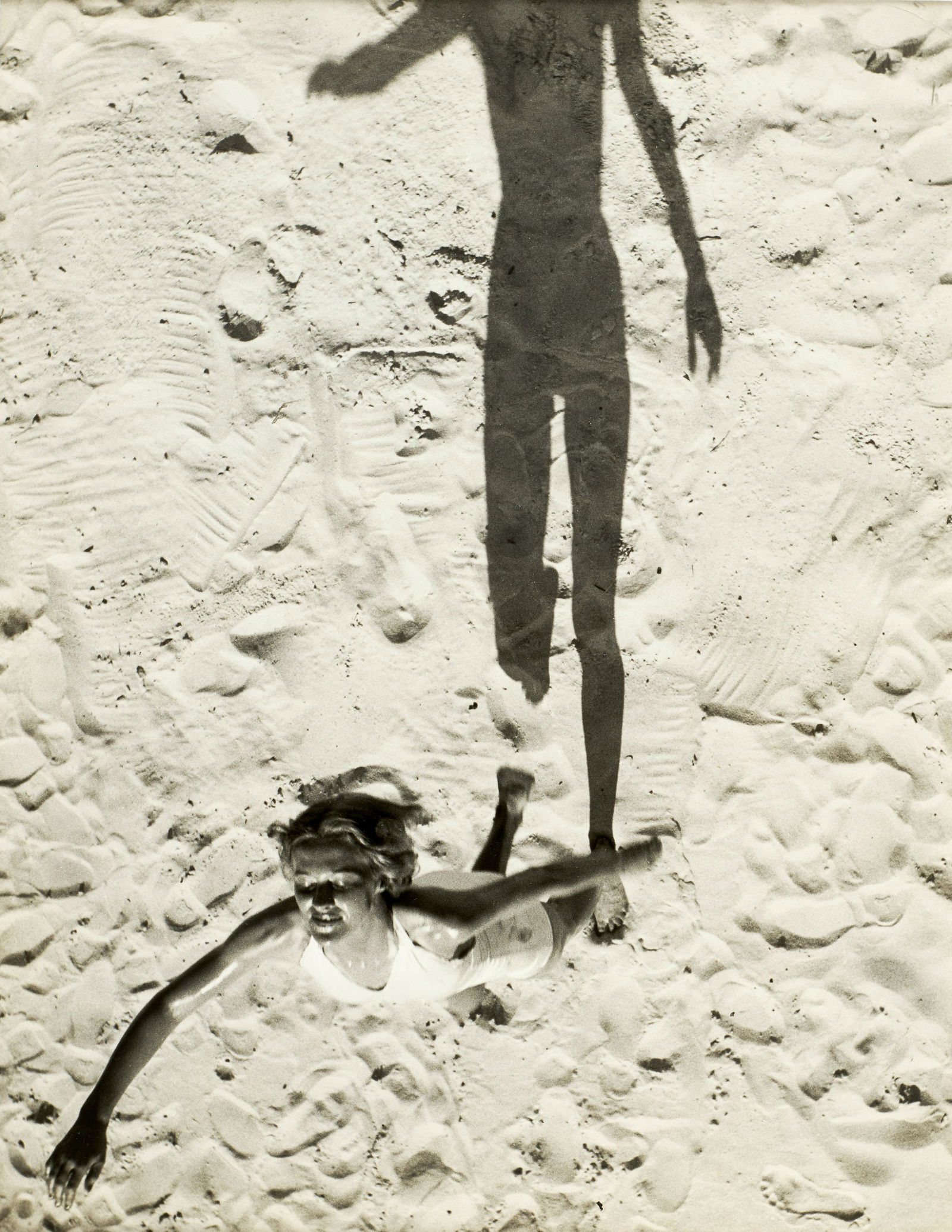 Herbert Matter (1907-1984); 'She and Her Shadow' (Jones Beach);: Herbert Matter (1907-1984) 'She and Her Shadow' (Jones Beach), 1939 Gelatin silver print; the artist's hand stamp, typed caption label, and Pix Publishing credit stamp on the verso. 10 x 8 in. (25.2 x