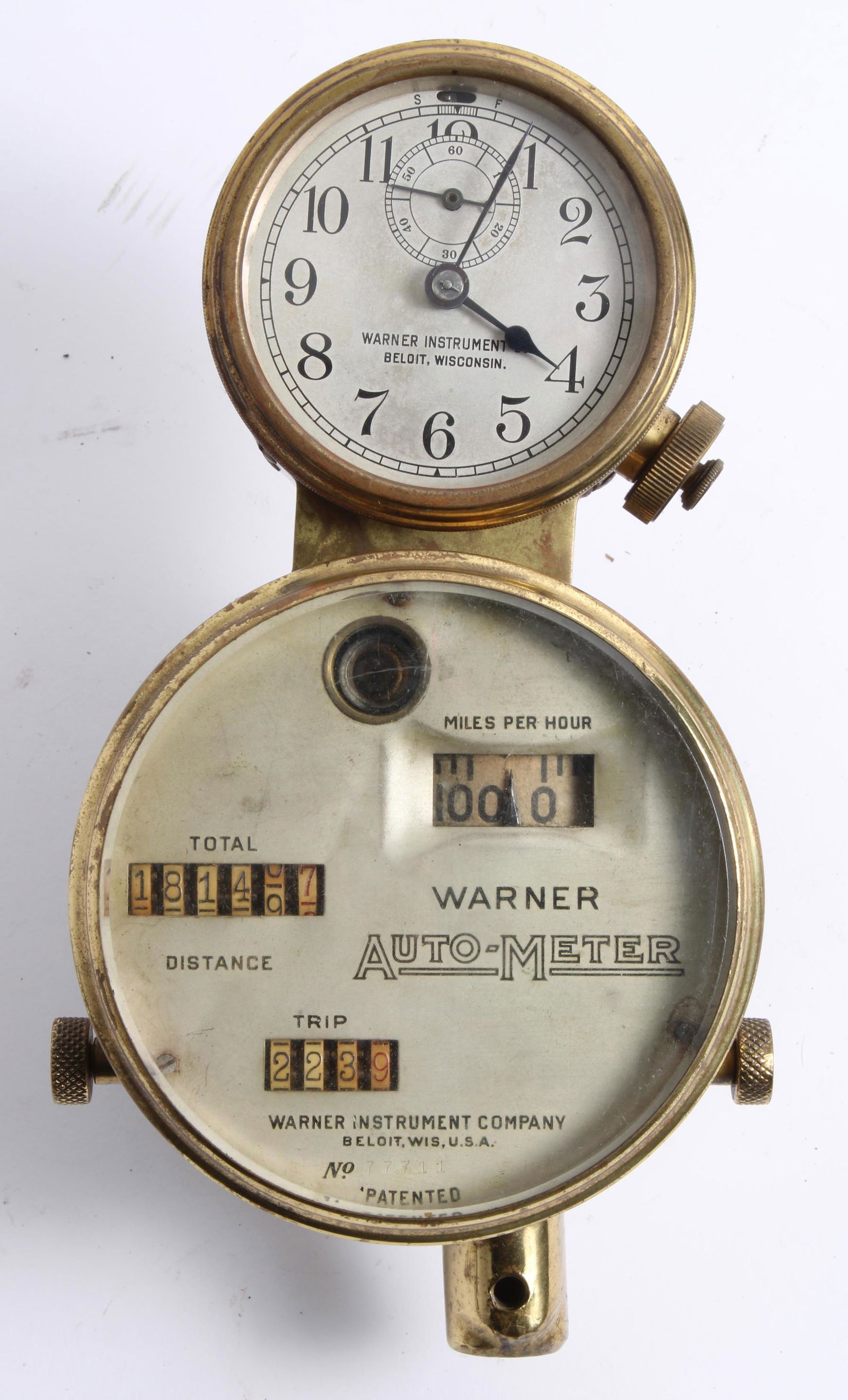 A Warner Auto-Meter dual instrument cluster by the Warner Instrument Co, American, circa 1910,: A Warner Auto-Meter dual instrument cluster by the Warner Instrument Co, American, circa 1910, comprising speedometer with milometer and trip, numbered 77711, 4 inch diameter bezel, surmounted with a