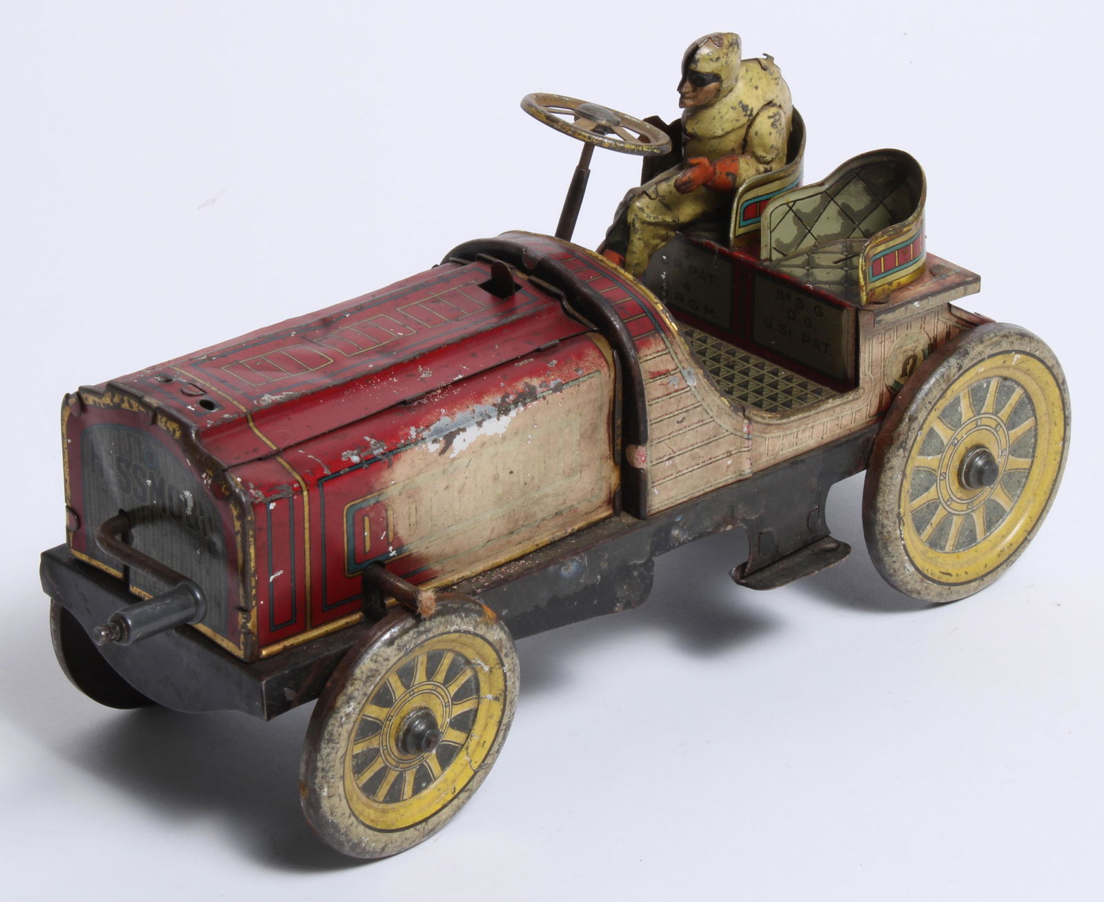 A Hessmobil tinplate car, German, circa 1908,: A Hessmobil tinplate car, German, circa 1908, red lithographed tinplate construction, flywheel driven, 10 inches long, (one side sun bleached, playworn). Lot to be sold without reserve. Buyer's Premiu