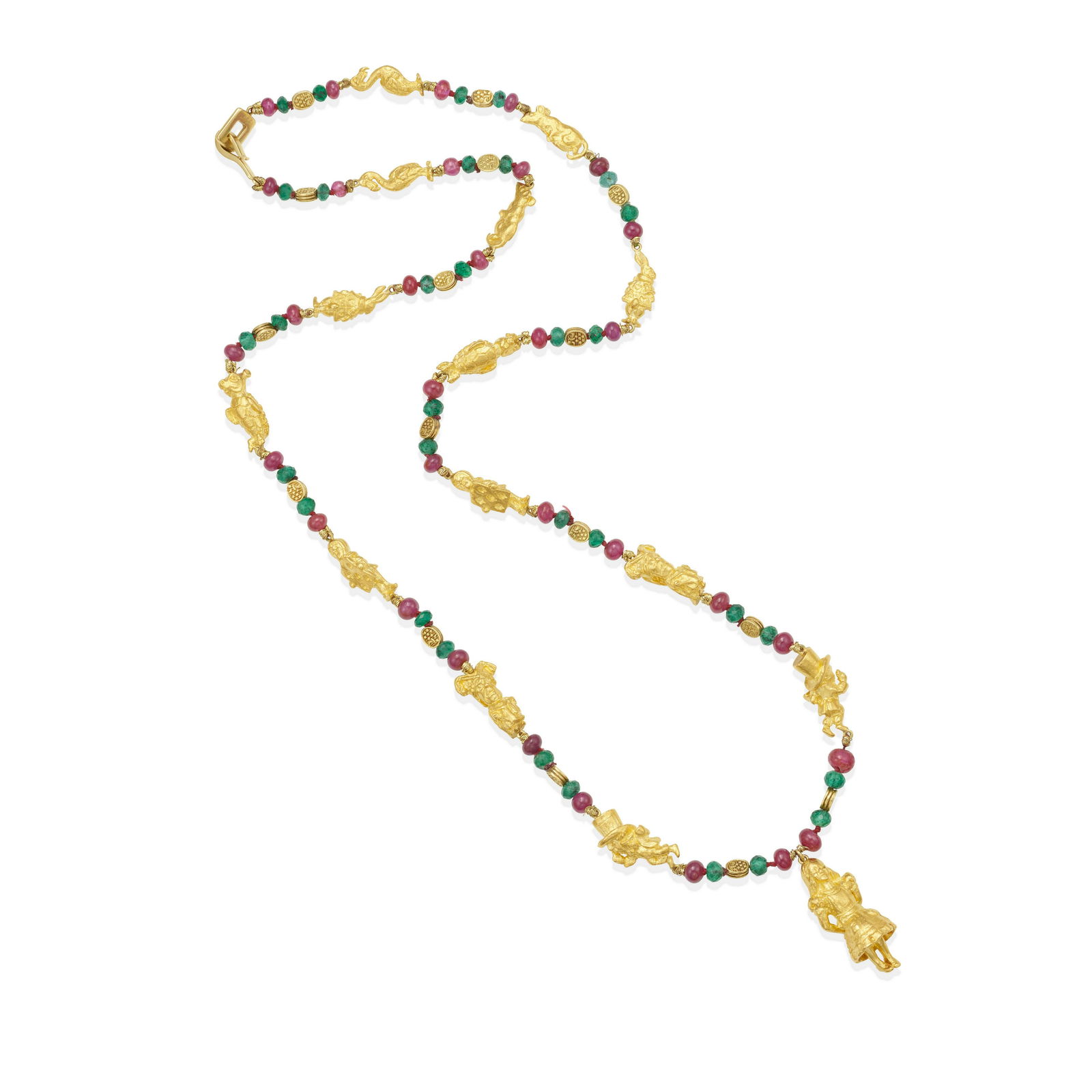 JULIUS COHEN: A 24K GOLD, RUBY AND EMERALD NECKLACE: JULIUS COHEN: A 24K GOLD, RUBY AND EMERALD NECKLACE An Alice in Wonderland themed necklace with high karat gold story characters interspersed with polished ruby and faceted emerald beads, signed Juliu