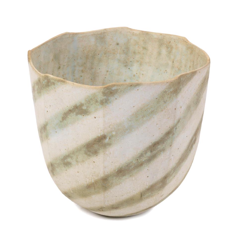 John Ward Faceted vessel: John Ward Faceted vessel Stoneware, cut-sided body with gently undulating rim, the matt white glaze with mottled green diagonal linear design, and mottled white and green interior. 16.5 cm high, 18 cm