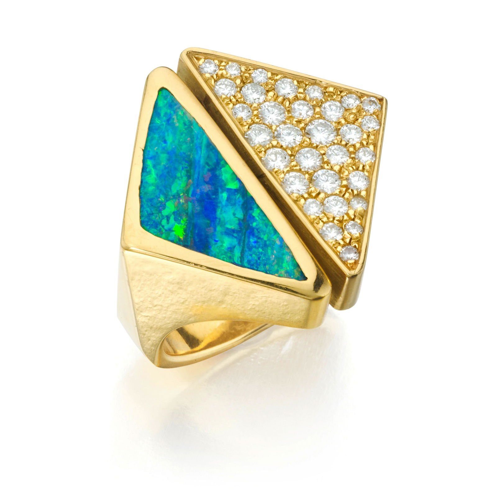 GRIMA: A DIAMOND AND OPAL RING, CIRCA 1986: GRIMA: A DIAMOND AND OPAL RING, CIRCA 1986 Designs as two triangular shaped plaques, one pavé-set with round diamonds and the other set with an opal; signed Grima; mounted in 18K gold; size 6