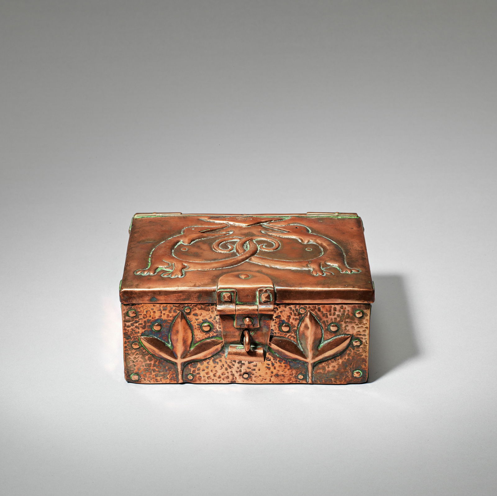 John Pearson Box and cover, dated 1904: John PearsonBox and cover, dated 1904Wood box with hinged cover, clad in copper, riveted and embossed on the top with two strange creatures, their tails entwined, and with leaf motifs on the front sid