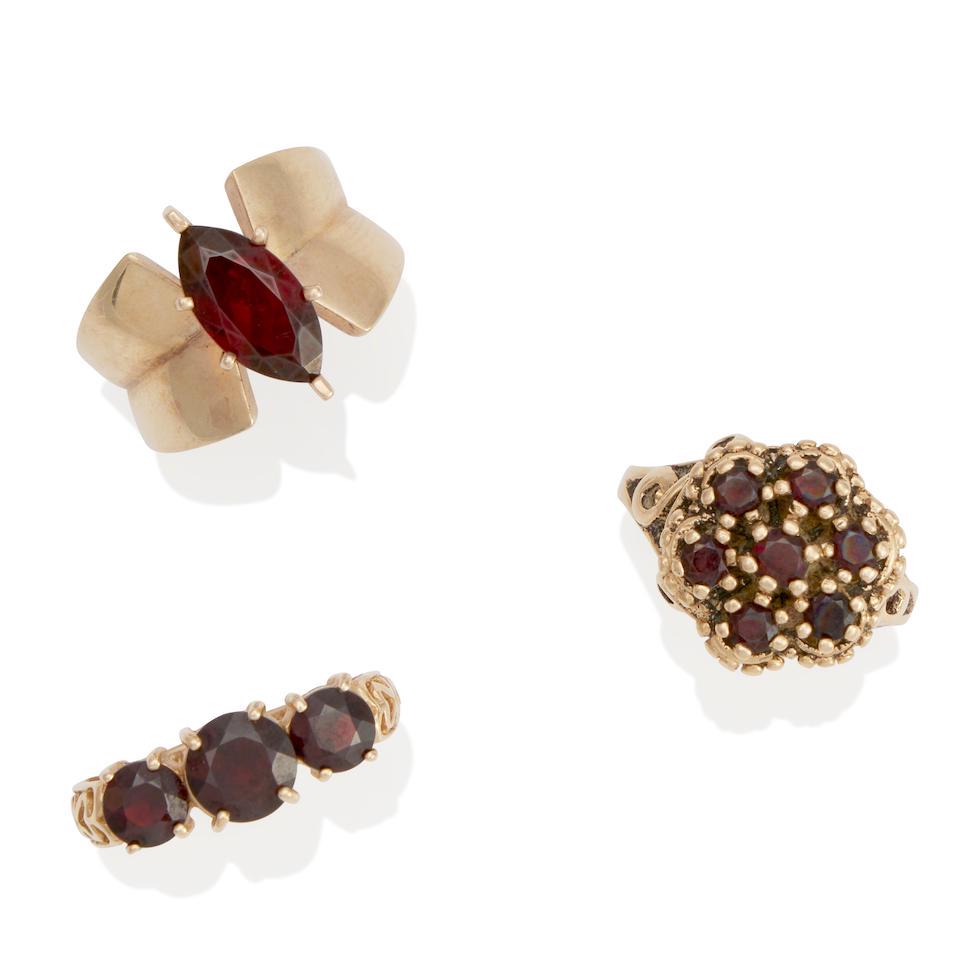 THREE 10K AND 14K GOLD AND GARNET RINGS: THREE 10K AND 14K GOLD AND GARNET RINGS Garnets, estimated gross weight 12.3 grams, one ring with maker's mark PDN, Thailand, one ring with maker's mark T&C, sizes 5 3/4, 6 and 7 Footnotes: OVERALL CO