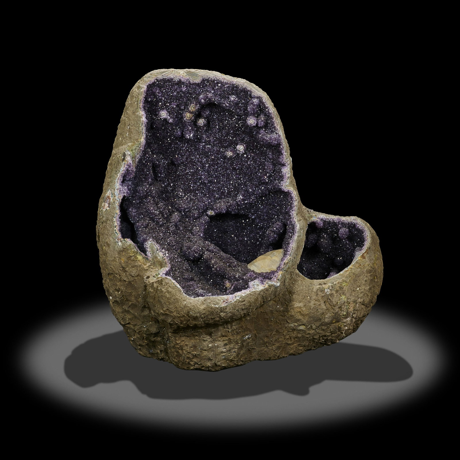 Egg-form Amethyst Geode with Calcite: Egg-form Amethyst Geode with Calcite Brazil Amethyst is a stone known for spiritual protection and purification. It can aid in overcoming overindulgence and bad habits, stimulate the crown chakra for 