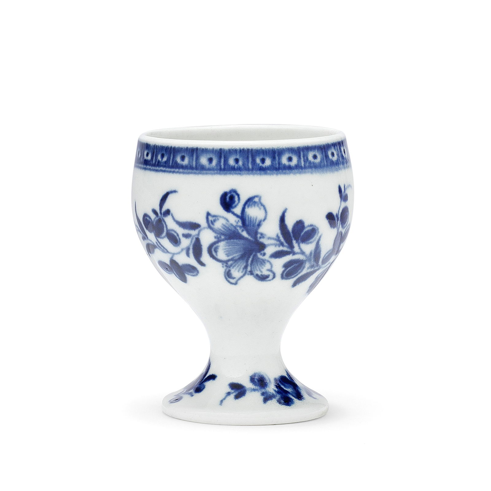 A rare Worcester egg cup, circa 1770: A rare Worcester egg cup, circa 1770Painted in blue with the 'Egg Cup Floral Sprays' pattern (I.E.11), leafy sprigs trailing around the pedestal foot and generous body, below a cell border, 6.7cm high