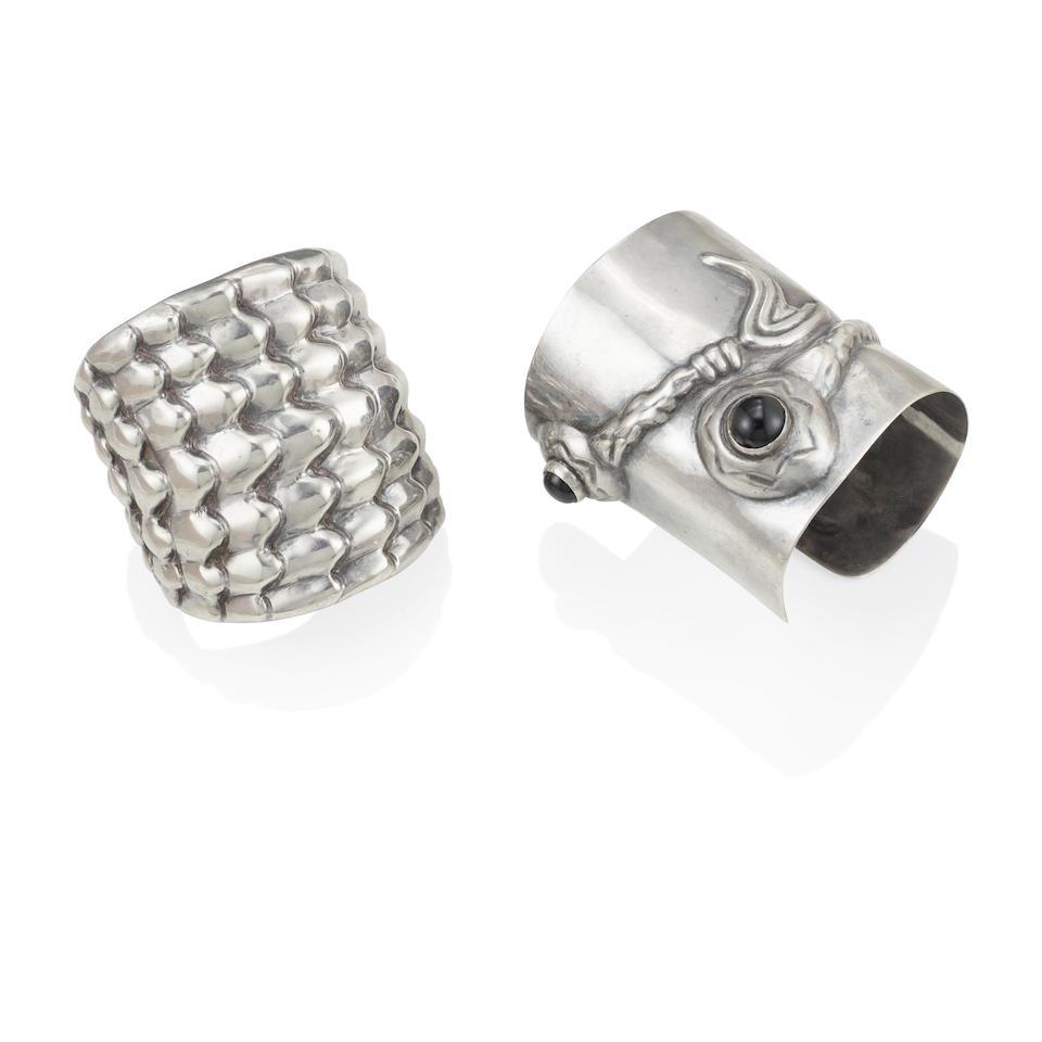 HUBERT HARMON: TWO SILVER AND GOLD SHEEN OBSIDIAN BRACELETS: HUBERT HARMON: TWO SILVER AND GOLD SHEEN OBSIDIAN BRACELETS Cuffs of fish and scale motif, accented by two round gold sheen obsidian cabochons, signed Hubert Harmon, with maker's mark, inner circumfer