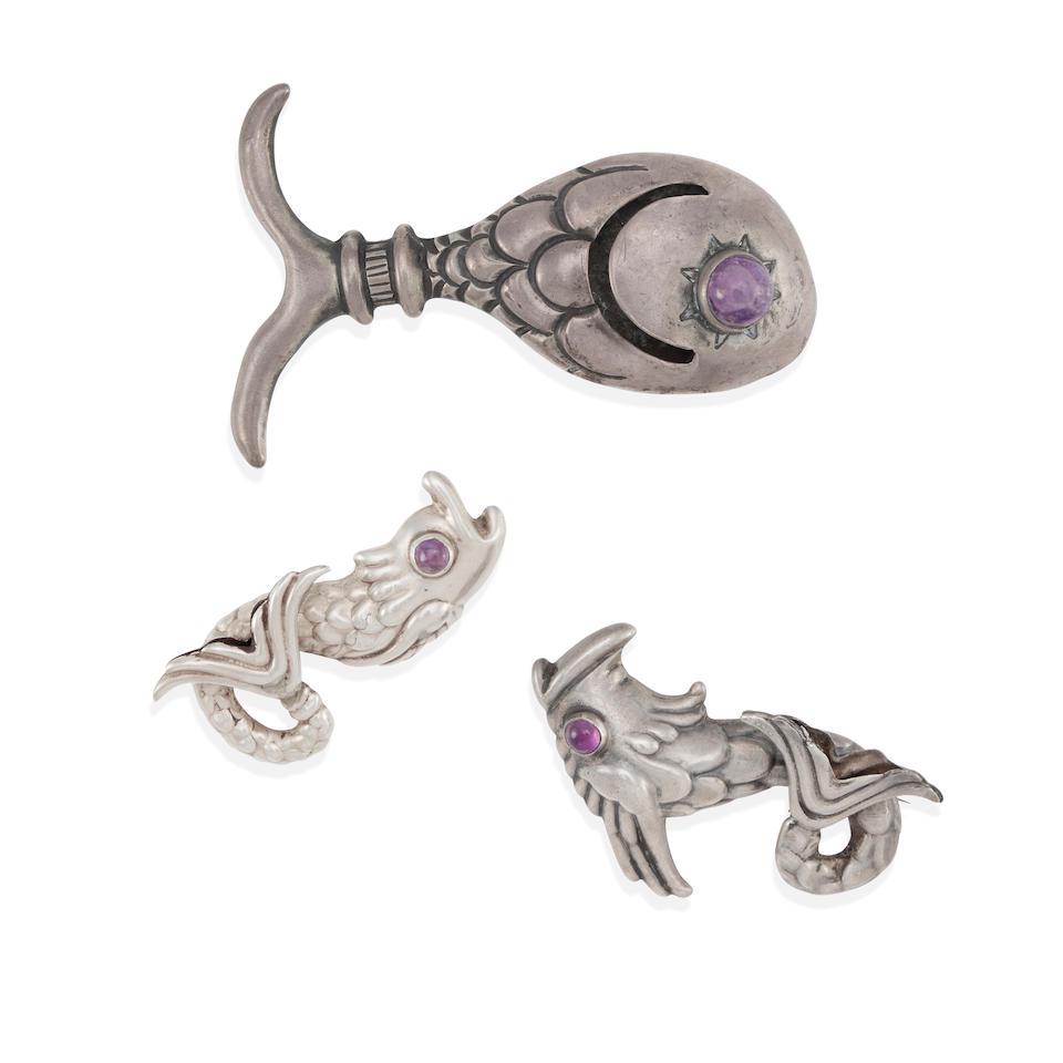 HUBERT HARMON: A GROUP OF SILVER AND AMETHYST BROOCHES: HUBERT HARMON: A GROUP OF SILVER AND AMETHYST BROOCHES Three repoussé brooches designed as fish set with round amethyst cabochon eyes, signed with maker's marks, Mexico, measure 2 1/4 x 1 1/8-3