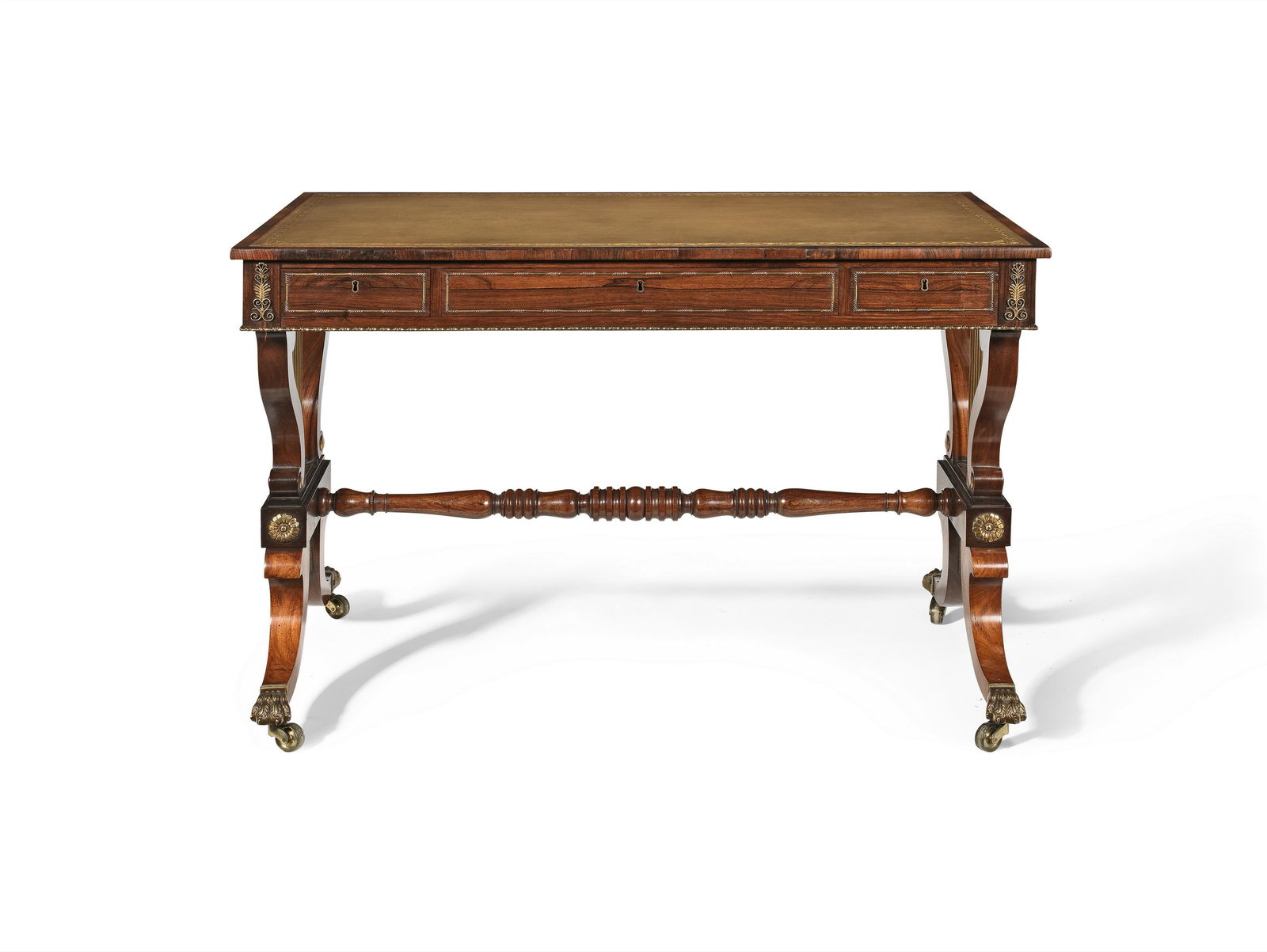 A Regency rosewood 'lyre-end' writing tableIn the manner of John McLean: A Regency rosewood 'lyre-end' writing table In the manner of John McLean The rectangular top with leather gilt-tooled inset, above three frieze drawers and opposing dummy drawer, with gilt metal mount