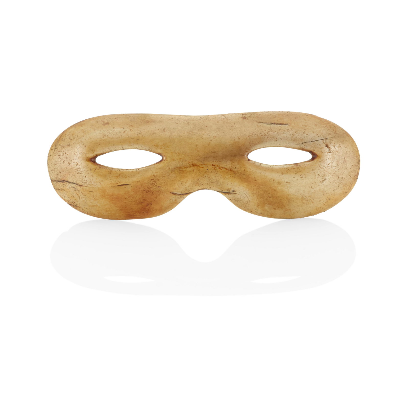 A pair of Inuit dance goggles: A pair of Inuit dance goggles Of bone or antler, in the style of snow goggles but with slightly larger eye holes; the bridge carved to evoke the snout of a seal. height 1 3/4, width 5 1/8in