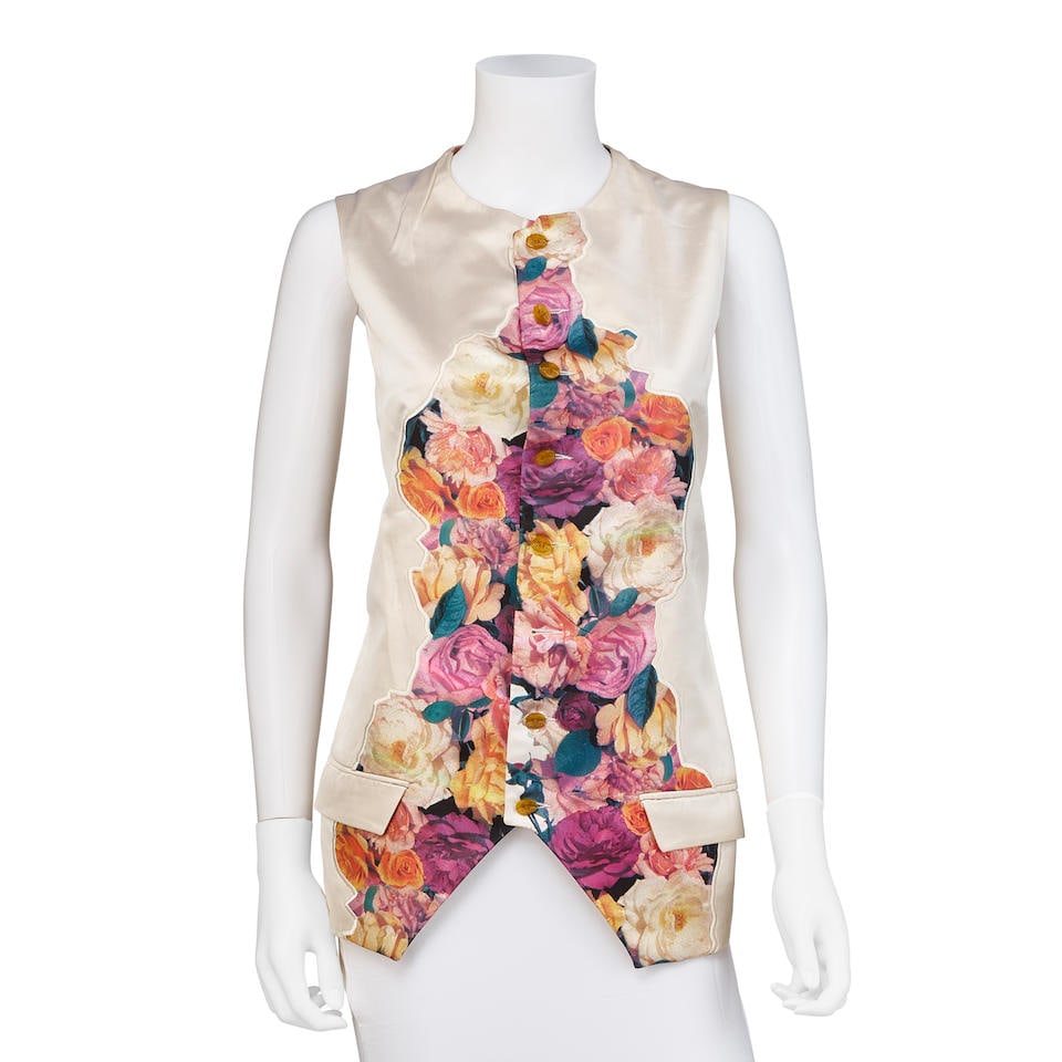 VIVIENNE WESTWOOD: RED LABEL 'CUT AND CLASH' SILK FLORAL VEST Spring/Summer 1991: VIVIENNE WESTWOOD: RED LABEL 'CUT AND CLASH' SILK FLORAL VEST Spring/Summer 1991 • Marked Size 40 • Silk Button Up Vest • Floral Collage Applique Footnotes: OVERALL CONDITION: Very G