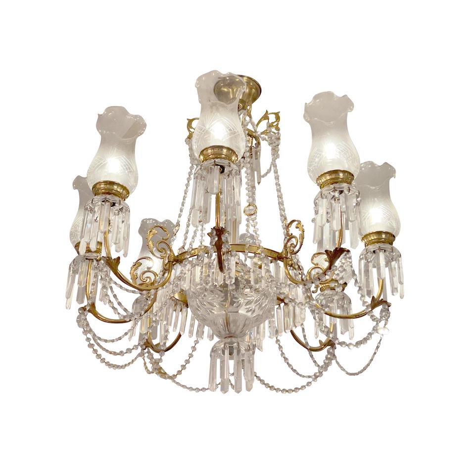 A FRENCH GLASS AND GILT METAL EIGHT-LIGHT CHANDELIER20th century: A FRENCH GLASS AND GILT METAL EIGHT-LIGHT CHANDELIER 20th century With glass shades. height approximately 24in (61cm); diameter 32in (81.3cm) Lot to be sold without reserve. For further information on
