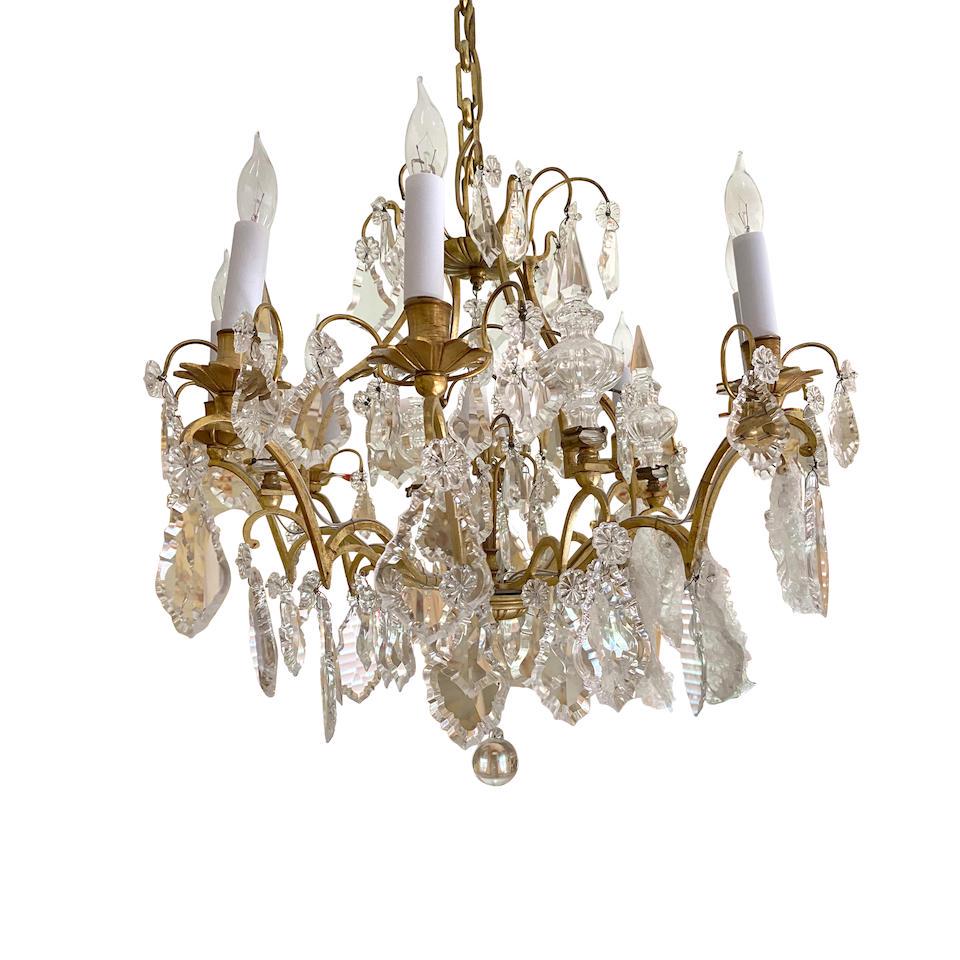A FRENCH GLASS GILT METAL EIGHT-LIGHT CHANDELIERFirst half 20th century: A FRENCH GLASS GILT METAL EIGHT-LIGHT CHANDELIER First half 20th century height approximately 18in (45.7cm); diameter 24in (61cm) Lot to be sold without reserve. For further information on this lot pl