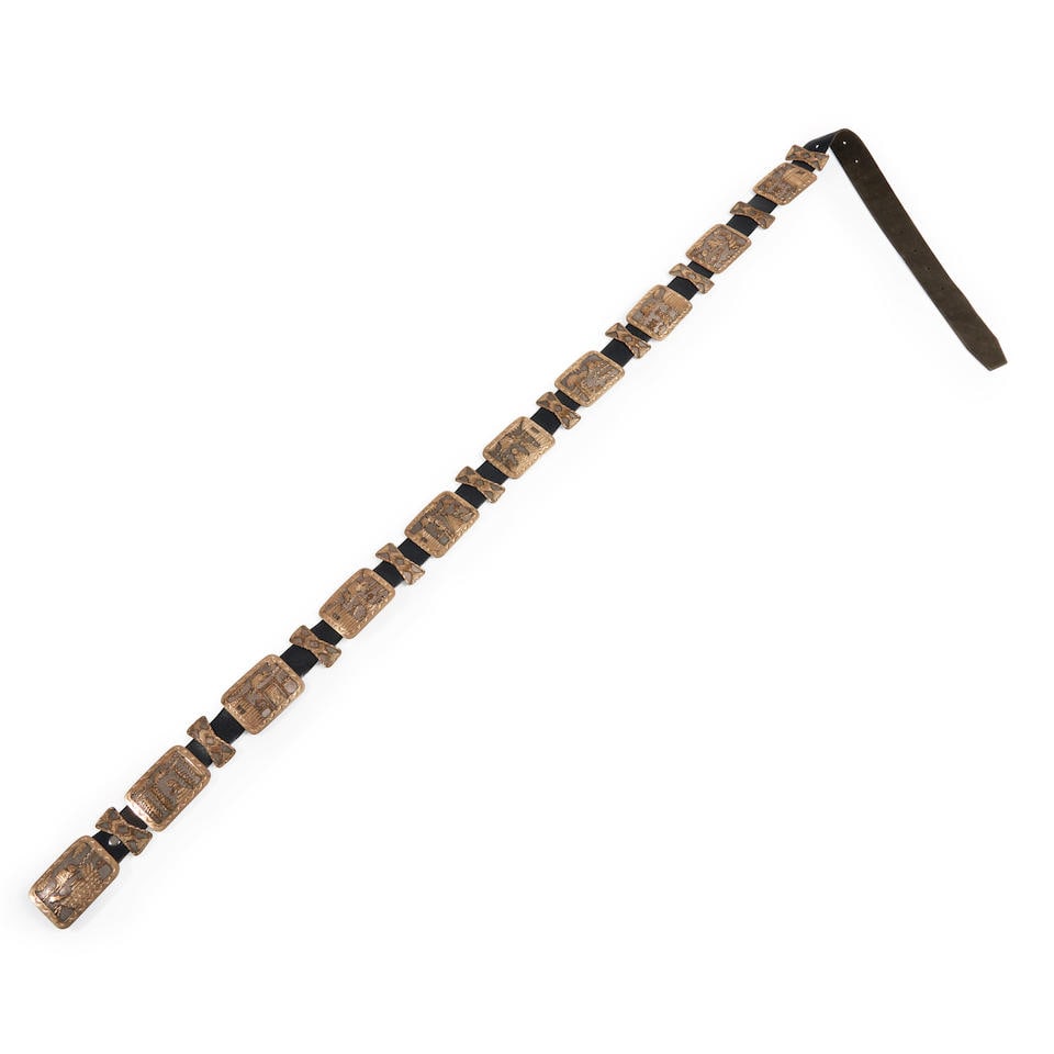 A Southwest silver pictorial concha belt lg. 52, size of concha 1 3/4 x 2 1/4 in.: A Southwest silver pictorial concha belt The leather belt with nine rectangular silver-gilt pictorial conchas with spacers inbetween, the buckle similar, marked, 'EB Sterling.' lg. 52, size of concha