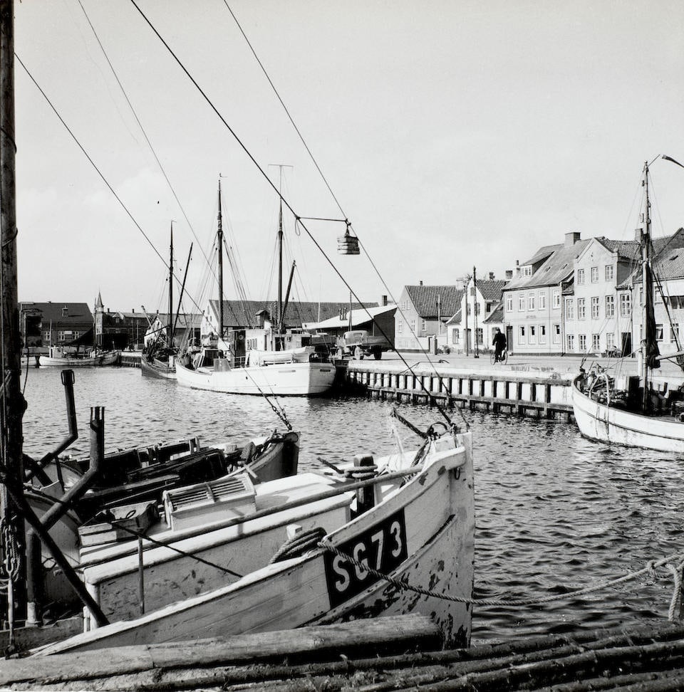 Esther Bubley (1921-1998); Faaborg Harbor, Denmark;: Esther Bubley (1921-1998) Faaborg Harbor, Denmark, 1954 Gelatin silver print; the photographer's credit stamp and a label with typed caption on the verso. 10 1/2 x 10 1/2 in. (26.7 x 26.7 cm.) Lot to