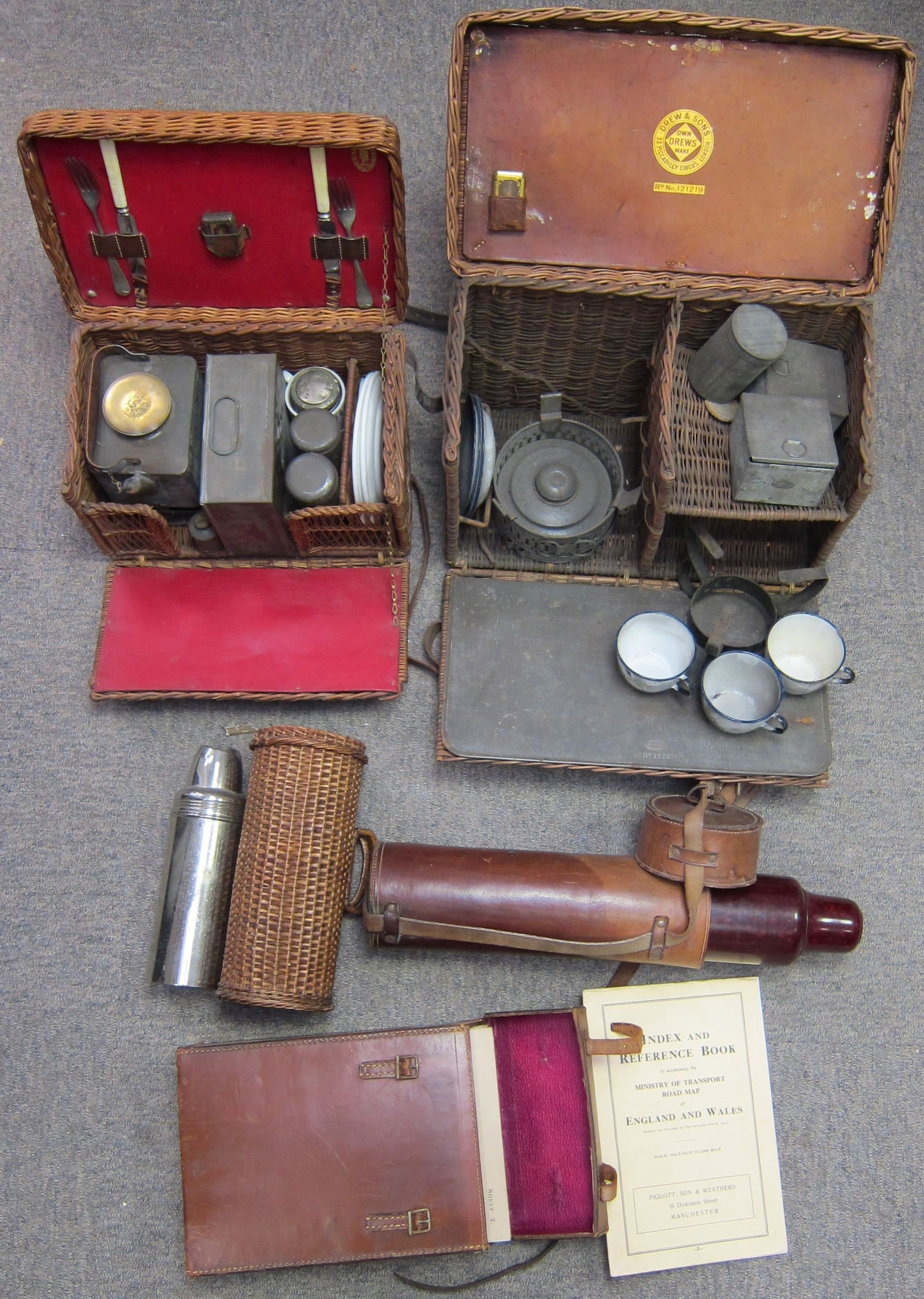 Two small wicker picnic sets, ((Qty)): Two small wicker picnic sets, comprising a two person set with kettle and burner in basket with red lining; another by Drew & Sons, London, (incomplete); two vacuum flasks one in wicker case, another