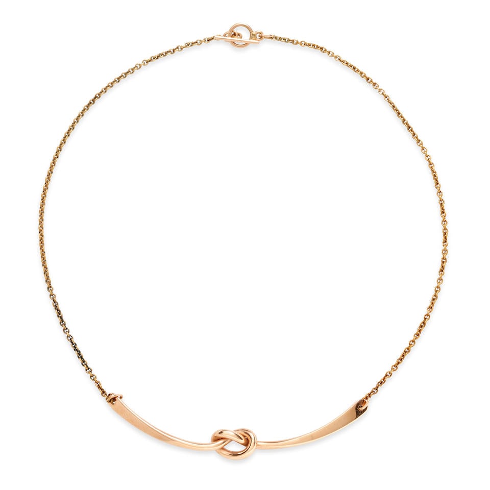 GEORG JENSEN: A 14K GOLD NECKLACE, DENMARK: GEORG JENSEN: A 14K GOLD NECKLACE, DENMARK Centering a rose gold pendant with a knot motif, weight 6.8 dwt, signed Georg Jensen, numbered A1051B, length 15 in. For further information on this lot plea