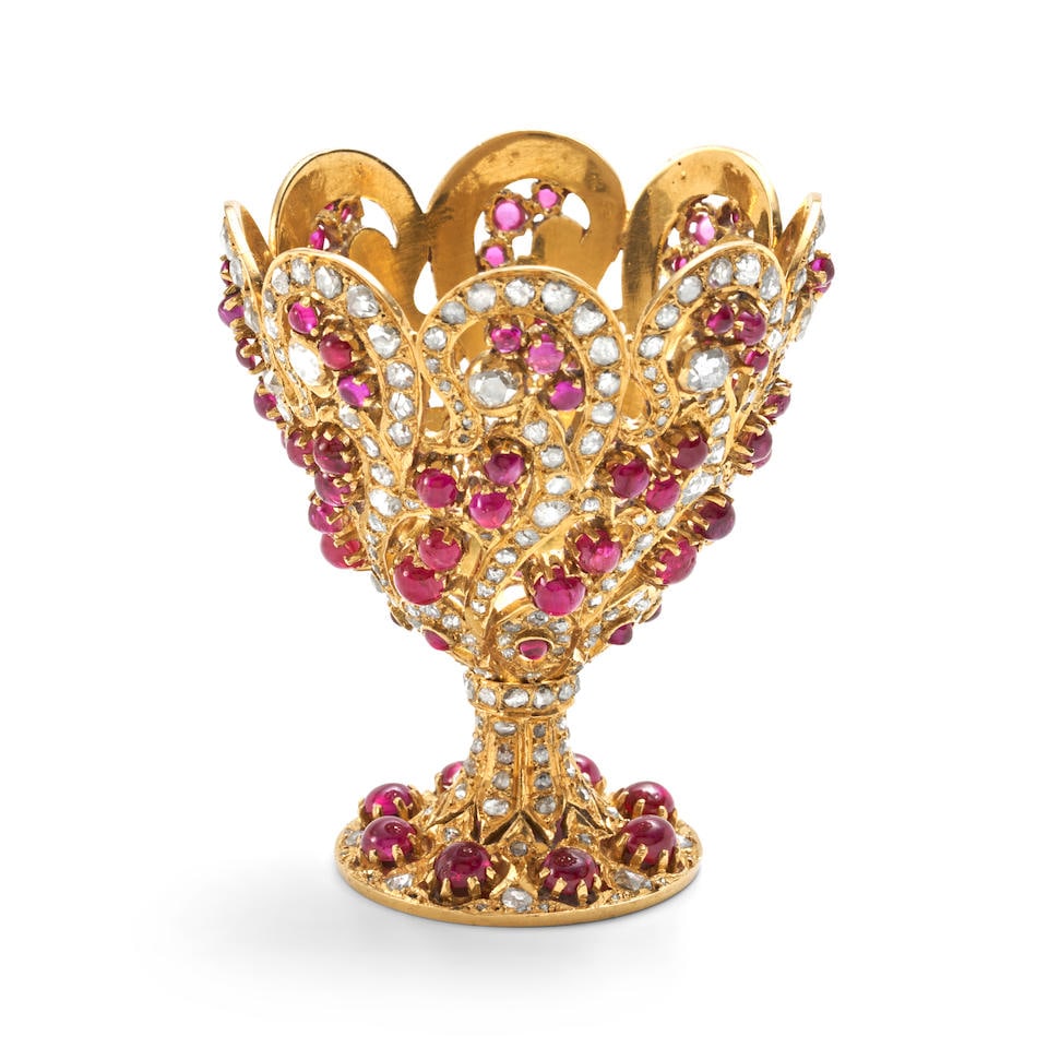 A HIGH KARAT GOLD, RUBY, AND DIAMOND EGG CUP: A HIGH KARAT GOLD, RUBY, AND DIAMOND EGG CUP Set with ruby cabochons and rose-cut diamonds, approximate total diamond weight 4.00 to 5.00 carats, weight 49.1 dwt, height 2 3/8 in. For further inform