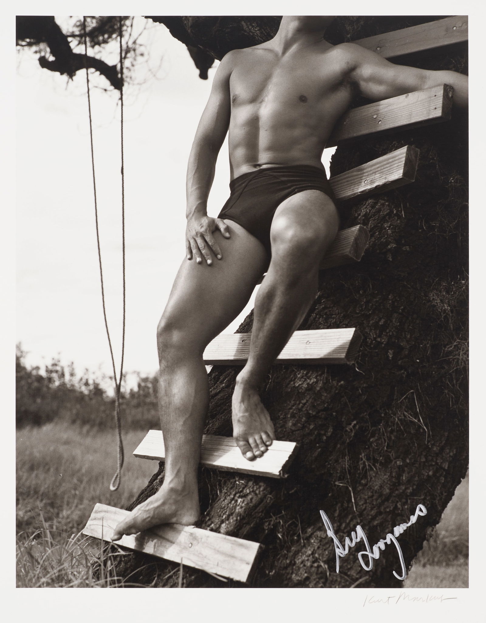 A KURT MARKUS PORTRAIT OF GREG LOUGANIS. MARKUS, KURT. 1947-2022. Greg Louganis, Hawaii, 1988. G...: A KURT MARKUS PORTRAIT OF GREG LOUGANIS. MARKUS, KURT. 1947-2022. Greg Louganis, Hawaii, 1988. Gelatin silver print of Louganis' legs and torso, 355 x 278 mm (14 x 11 inches), signed ('Greg Louganis')