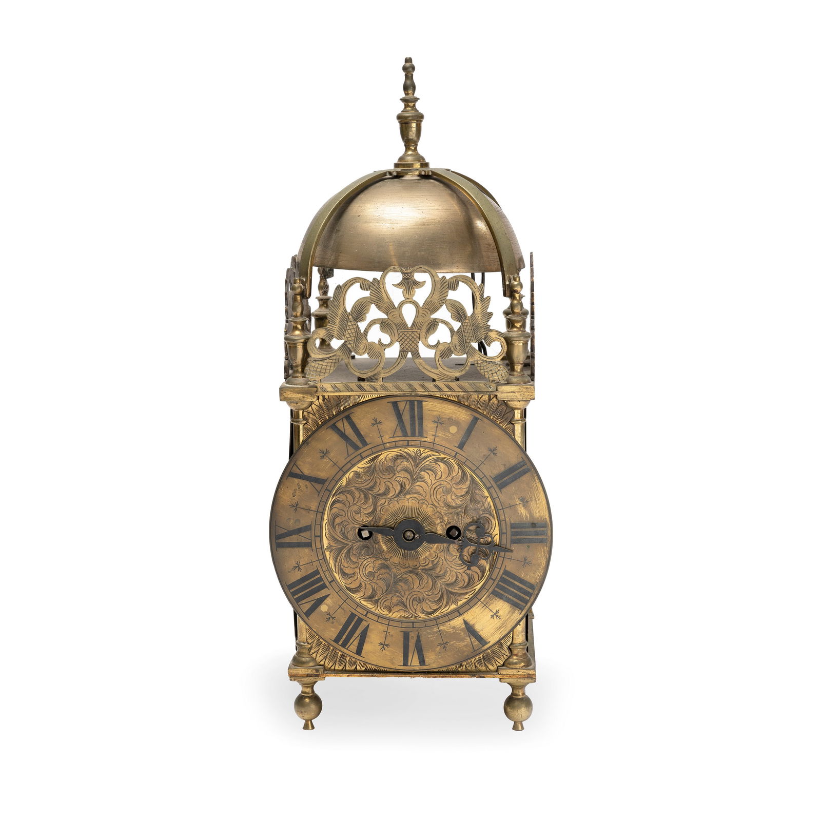 A 19th century brass lantern clock in the 17th century style: A 19th century brass lantern clock in the 17th century style the typical four pillar case with foliate scrolling crestings to the front and sides, the corners with urn finials to a strapped bell with