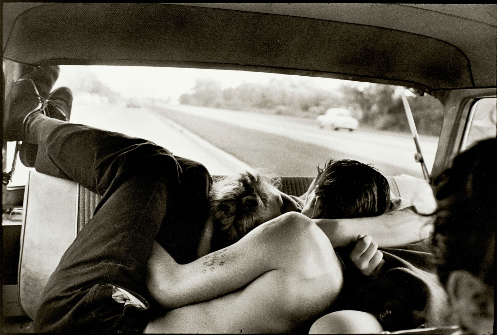 Bruce Davidson (born 1933); Brooklyn Gang (Couple Kissing in the Backseat of a Car);: Bruce Davidson (born 1933) Brooklyn Gang (Couple Kissing in the Backseat of a Car), 1959 Gelatin silver print, printed later; signed in pencil on the reverse. 12 3/4 x 19 7/8 in. (32.4 x 50.5 cm.) she