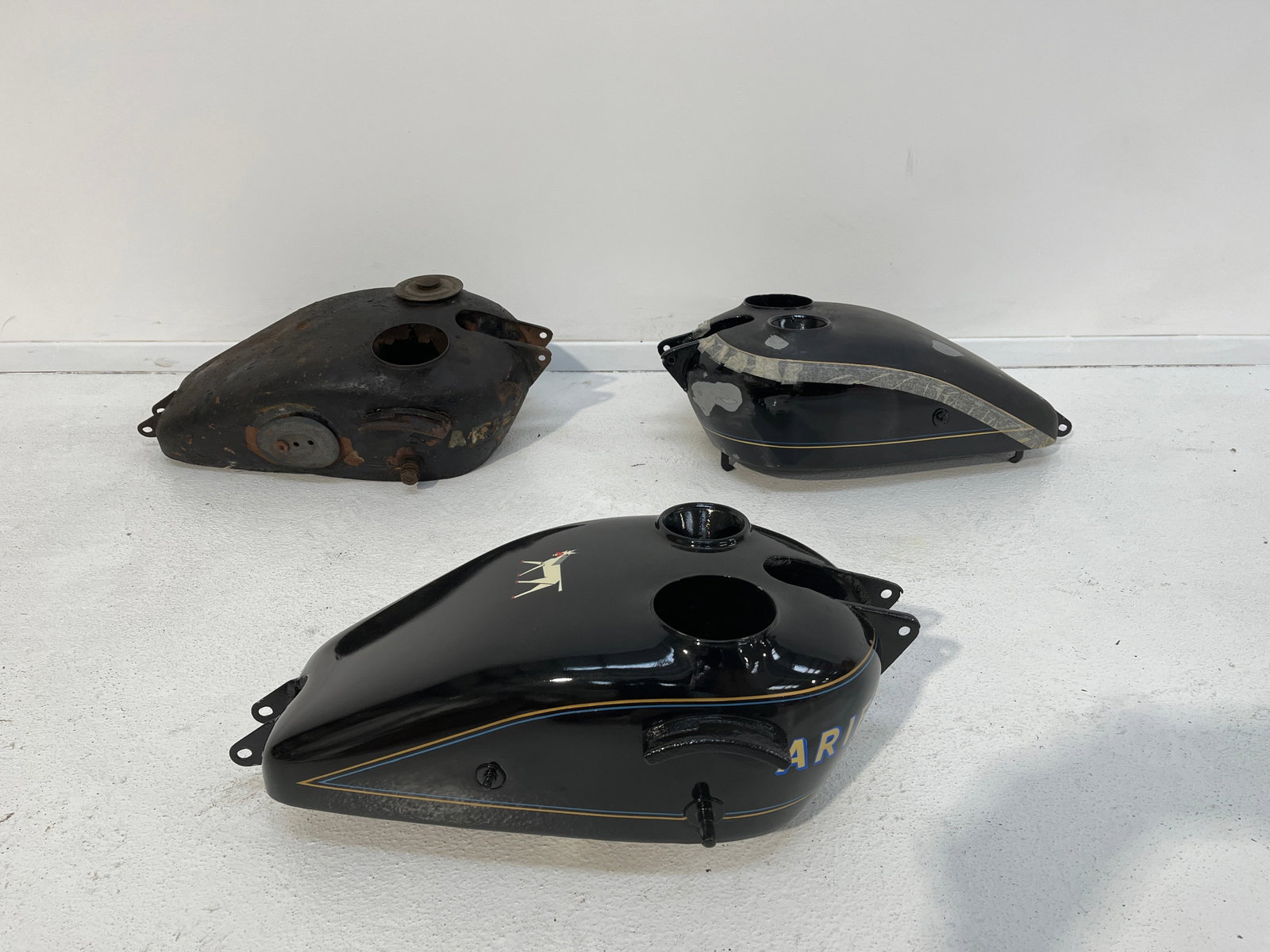 Three believed Ariel petrol tanks ((3)): Three believed Ariel petrol tanks believed late 1920's 250cc type. Varying states of condition. Prospective bidders must satisfy themselves as to the condition, completeness, correctness, compatibilit