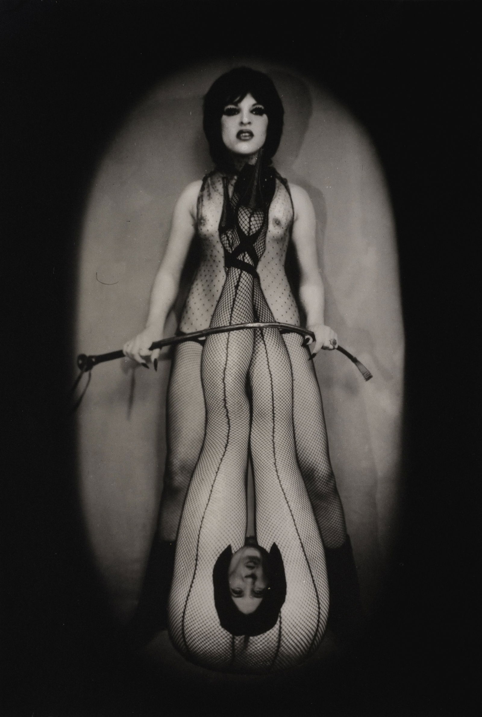 Pierre Molinier (1900-1976) Cravache, planche 53 du 'Chaman et ses Créatures', avec visage ...: Pierre Molinier (1900-1976) Cravache, planche 53 du 'Chaman et ses Créatures', avec visage grimaçant du Petit Vampire. Tirage argentique d'époque. Gelatin silver print. 17 x 12 cm. F