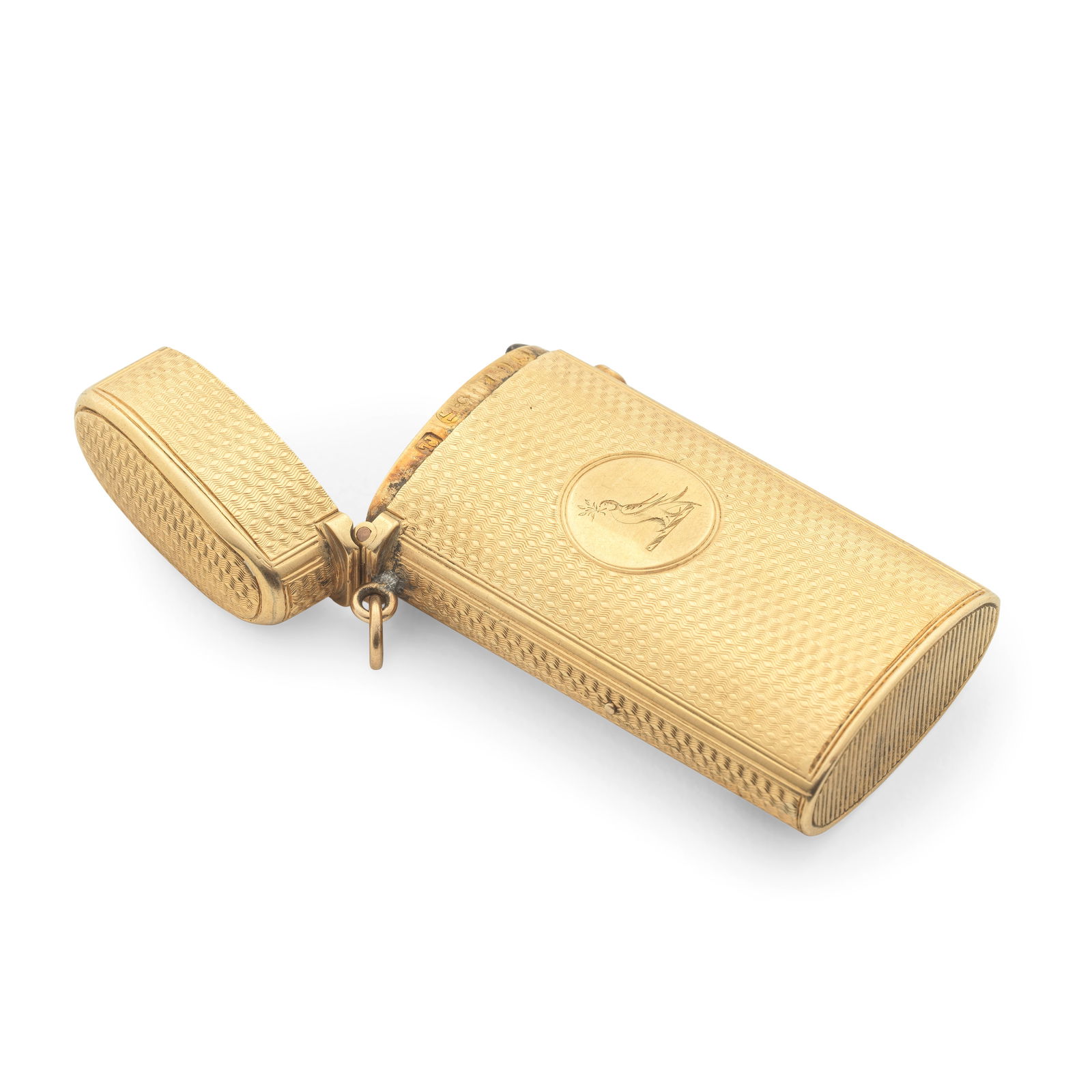 A Victorian 15 carat gold vesta case Thomas Johnson, London 1863: A Victorian 15 carat gold vesta case Thomas Johnson, London 1863 Compressed ovoid form with all-over engine turned surface, one side a plain roundel with engraved crested for the WESTBY family, push a