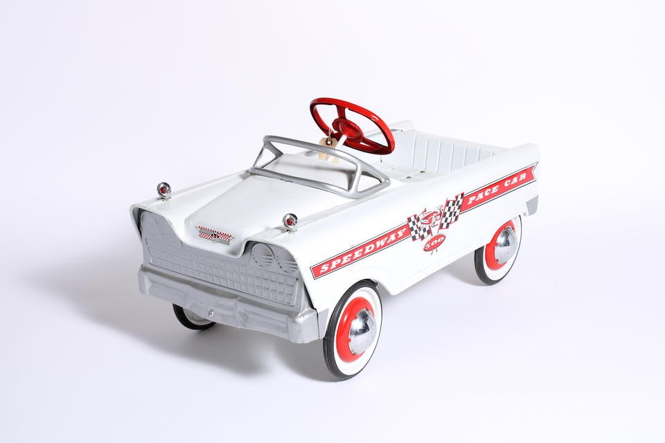 A 'Speedway 500 Pace Car' pedal car after a 1960s design by Murray: A 'Speedway 500 Pace Car' pedal car after a 1960s design by Murray modern, pressed steel body, white with red wheels and steering wheel, 36 inches long, (some playwear) Saleroom notices: Please note t