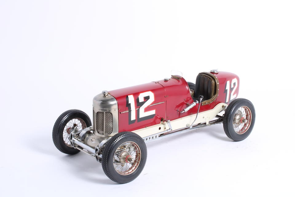 A model of a 1927 Indianapolis Miller car by Fred Briancone, (2): A model of a 1927 Indianapolis Miller car by Fred Briancone, finished in deep red, numbered 12 (based upon Leon Duray's car), 18 inches long, for display only, together with a page from a book depicti